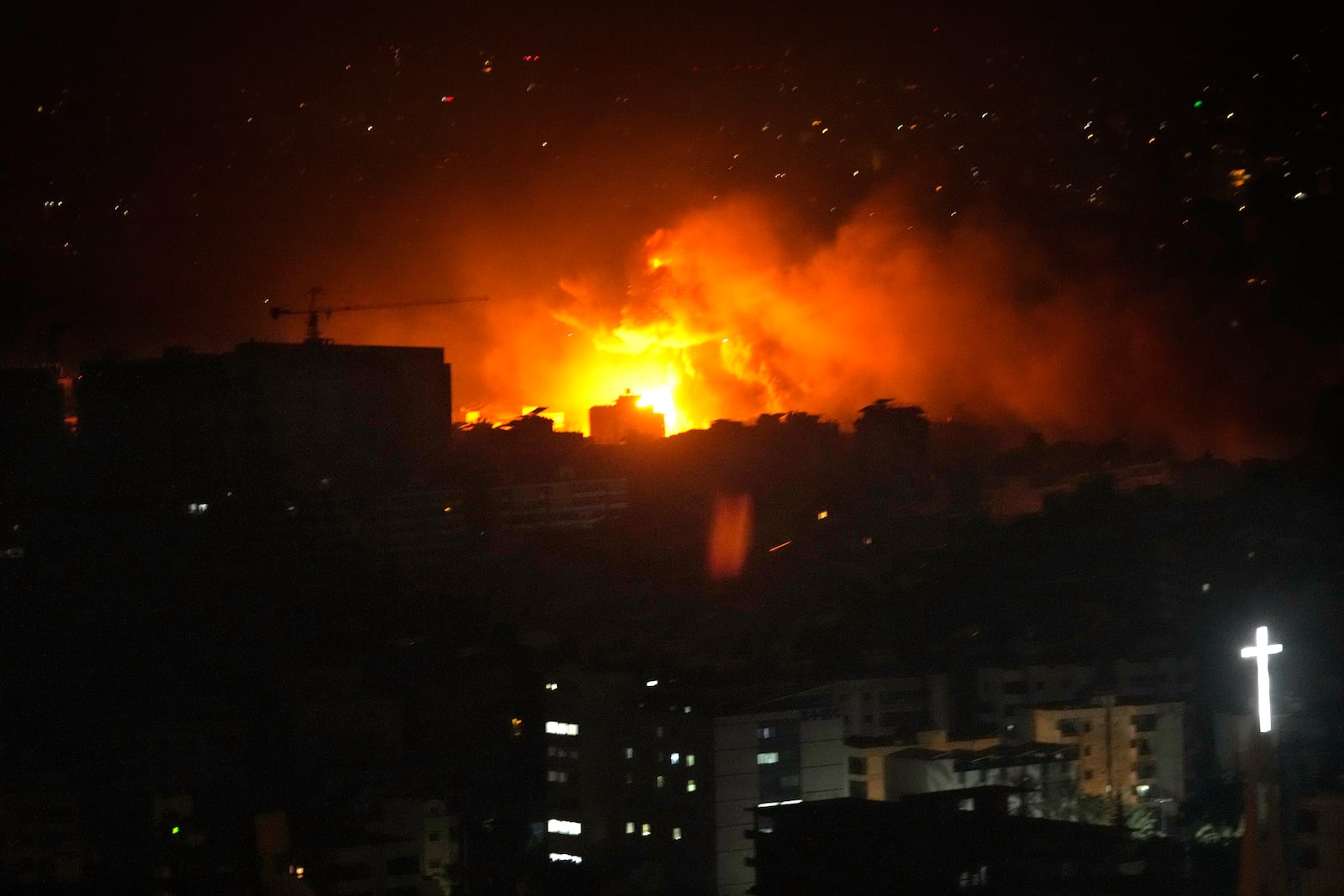 Flames and smoke rise from an Israeli airstrike in Dahiyeh, Beirut, Lebanon, early Sunday, Oct. 6, 2024. (AP Photo/Hussein Malla)