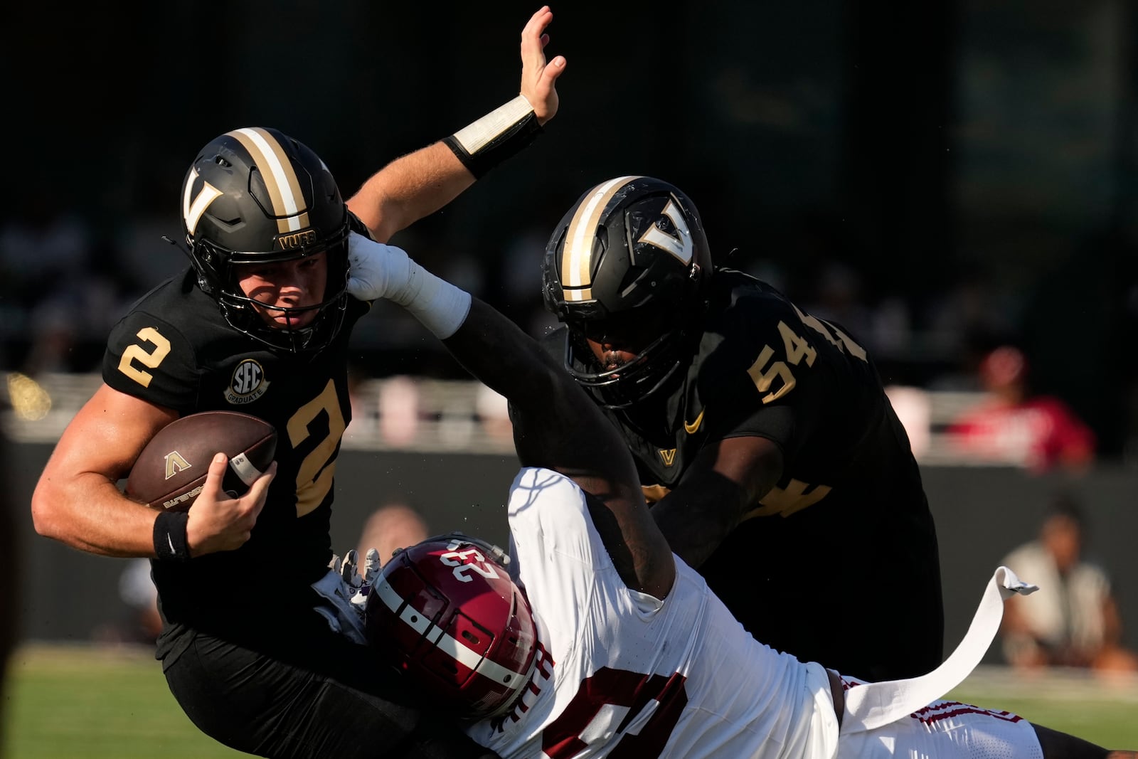 Vanderbilt quarterback Diego Pavia (2) spins away from Alabama defensive lineman James Smith (23) during the first half of an NCAA college football game Saturday, Oct. 5, 2024, in Nashville, Tenn. (AP Photo/George Walker IV)