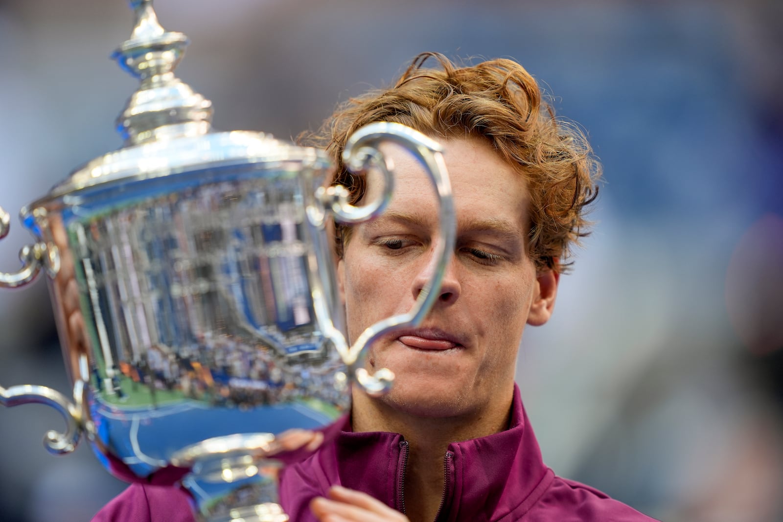 Jannik Sinner, of Italy, holds up the championship trophy after defeating Taylor Fritz, of the United States, in the men's singles final of the U.S. Open tennis championships, Sunday, Sept. 8, 2024, in New York. (AP Photo/Julia Nikhinson)