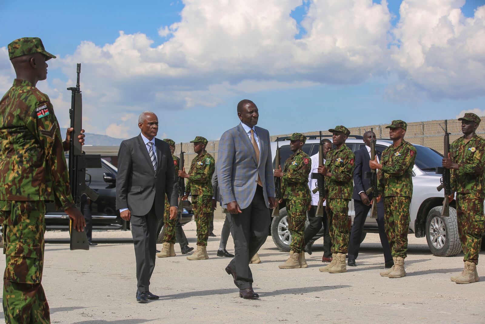 Kenya's President William Ruto, center right, walks with Transition Council President Edgard Leblanc, as they arrive to the Kenyan base in Port-au-Prince, Haiti, Saturday, Sept. 21, 2024. (AP Photo/Odelyn Joseph)