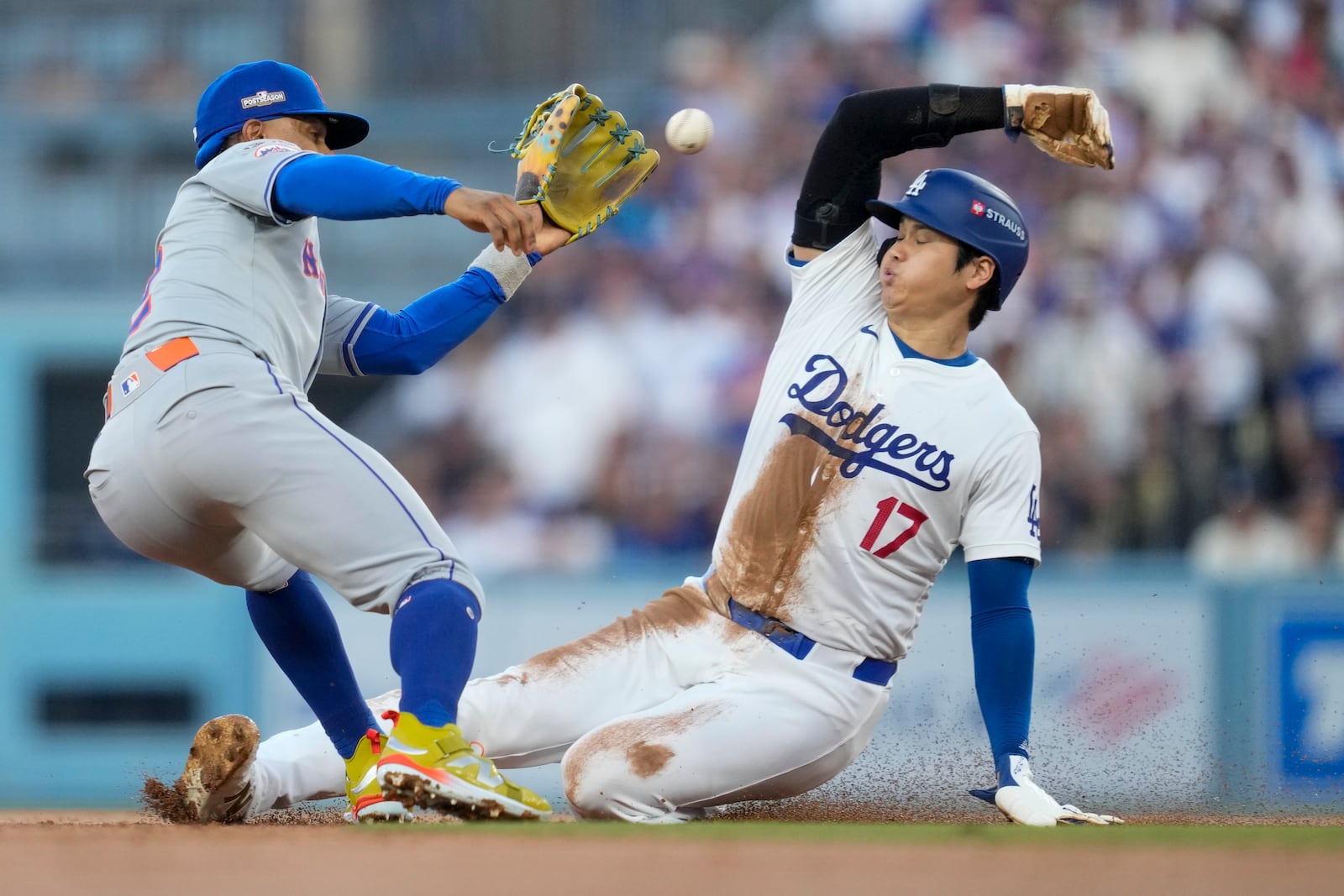 Los Angeles Dodgers' Shohei Ohtani gets caught stealing by New York Mets shortstop Francisco Lindor during the second inning in Game 1 of a baseball NL Championship Series, Sunday, Oct. 13, 2024, in Los Angeles. (AP Photo/Ashley Landis)