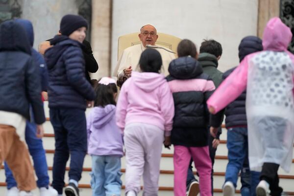 Pope Francis greets a group of children during his weekly general audience in St. Peter's Square at The Vatican, Wednesday, Nov.20, 2024. (AP Photo/Gregorio Borgia)