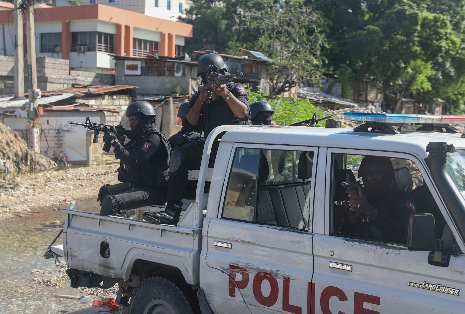 Police officers patrol the area during an exchange of gunfire between gangs and police in Port-au-Prince, Haiti, Monday, Nov. 11, 2024. (AP Photo/Odelyn Joseph)