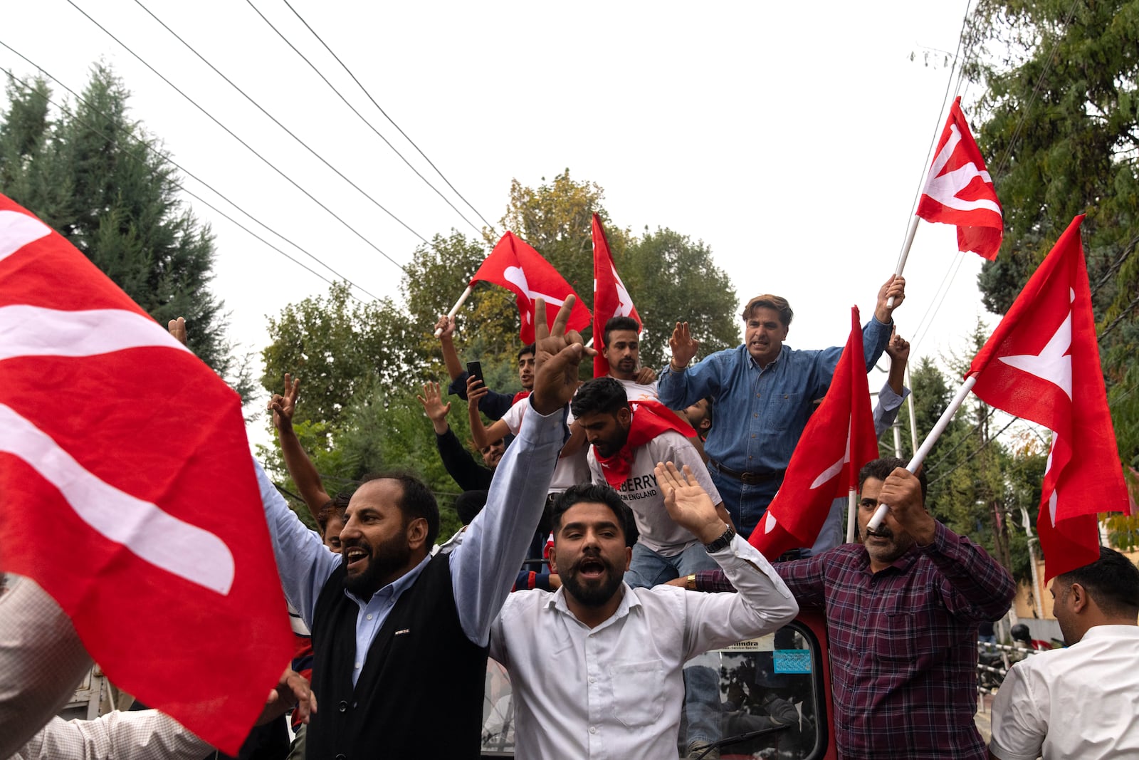 Supporters of National Conference party shout slogans as they celebrate early leads in the election for a local government in Indian controlled Kashmir, Srinagar, Tuesday, Oct. 8, 2024. (AP Photo/Dar Yasin)