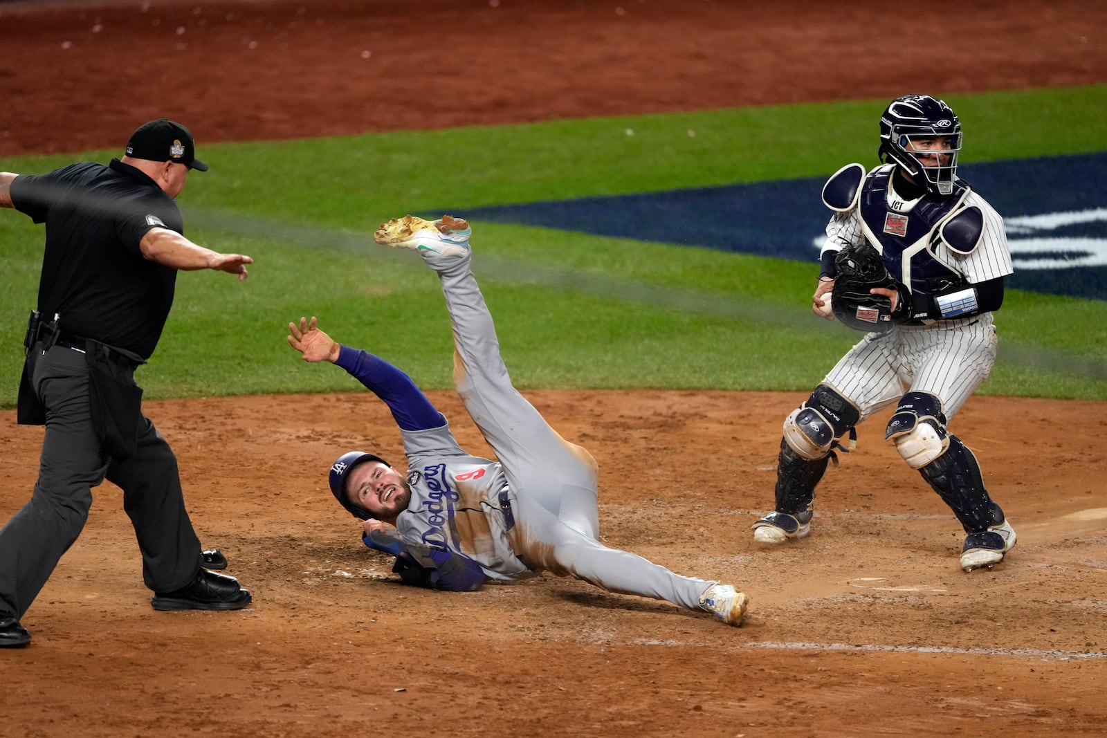 Los Angeles Dodgers' Gavin Lux (9) is safe at home plate as New York Yankees catcher Jose Trevino looks to the infield during the sixth inning in Game 3 of the baseball World Series, Monday, Oct. 28, 2024, in New York. (AP Photo/Seth Wenig)