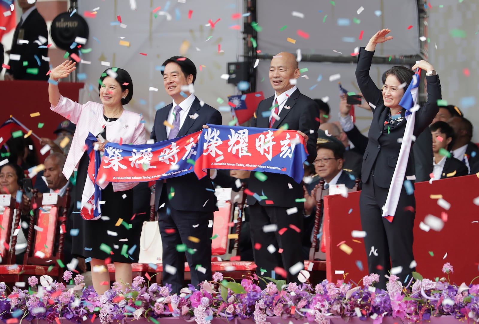 From left, Taiwan first lady Wu Mei-ru, Taiwanese President Lai Ching-te, Speaker of the Legislature Han Guo-yu and Vice President Hsiao Bi-khim cheer during National Day celebrations in front of the Presidential Building in Taipei, Taiwan, Thursday, Oct. 10, 2024. (AP Photo/Chiang Ying-ying)