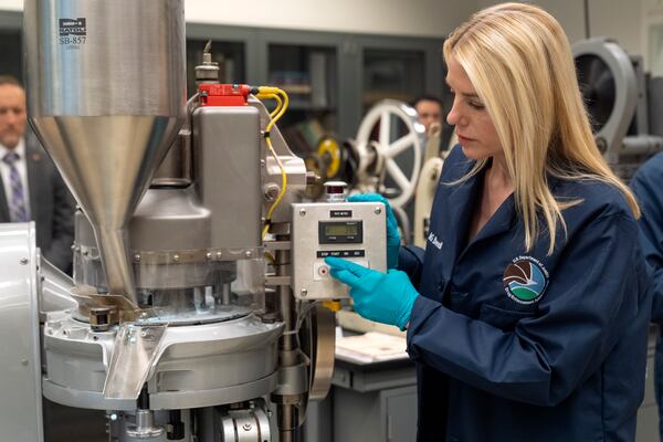 Attorney General Pam Bondi operates a a tablet press machine as it manufactures simulated fentanyl pills at a Drug Enforcement Administration (DEA) research laboratory on Tuesday, April 29, 2025, in Northern Virginia. (AP Photo/Mark Schiefelbein)