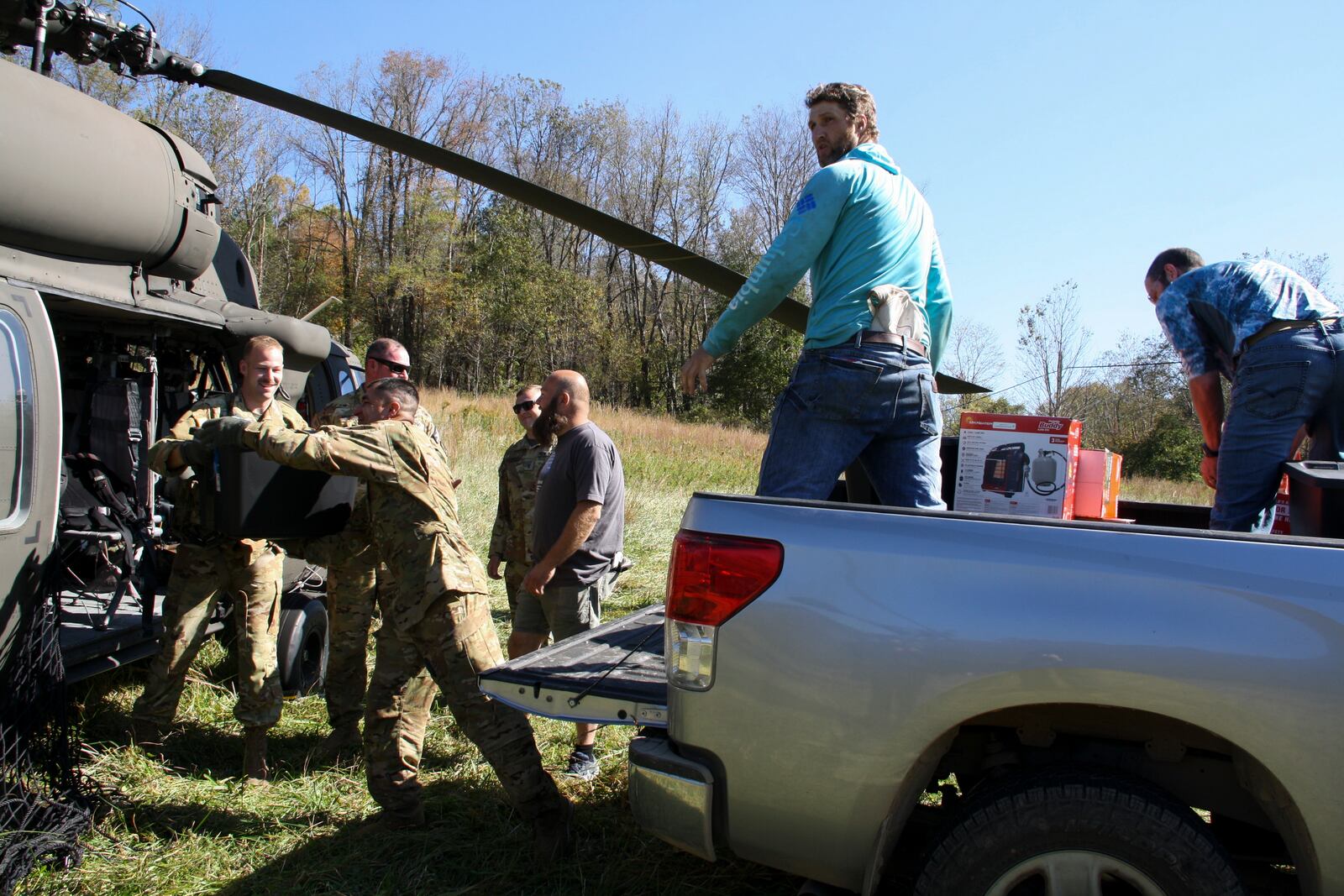 National Guard members deliver essential supplies to residents in the aftermath of Hurricane Helene, Tuesday, Oct. 8, 2024, in Elk Park, N.C. (AP Photo/Makiya Seminera)