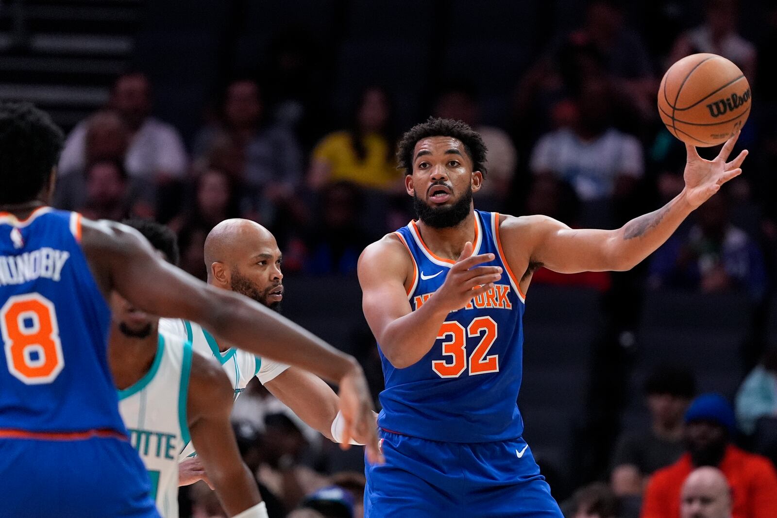 New York Knicks center Karl-Anthony Towns passes to forward OG Anunoby during the first half of a preseason NBA basketball game against the Charlotte Hornets, Sunday, Oct. 6, 2024, in Charlotte, N.C. (AP Photo/Chris Carlson)