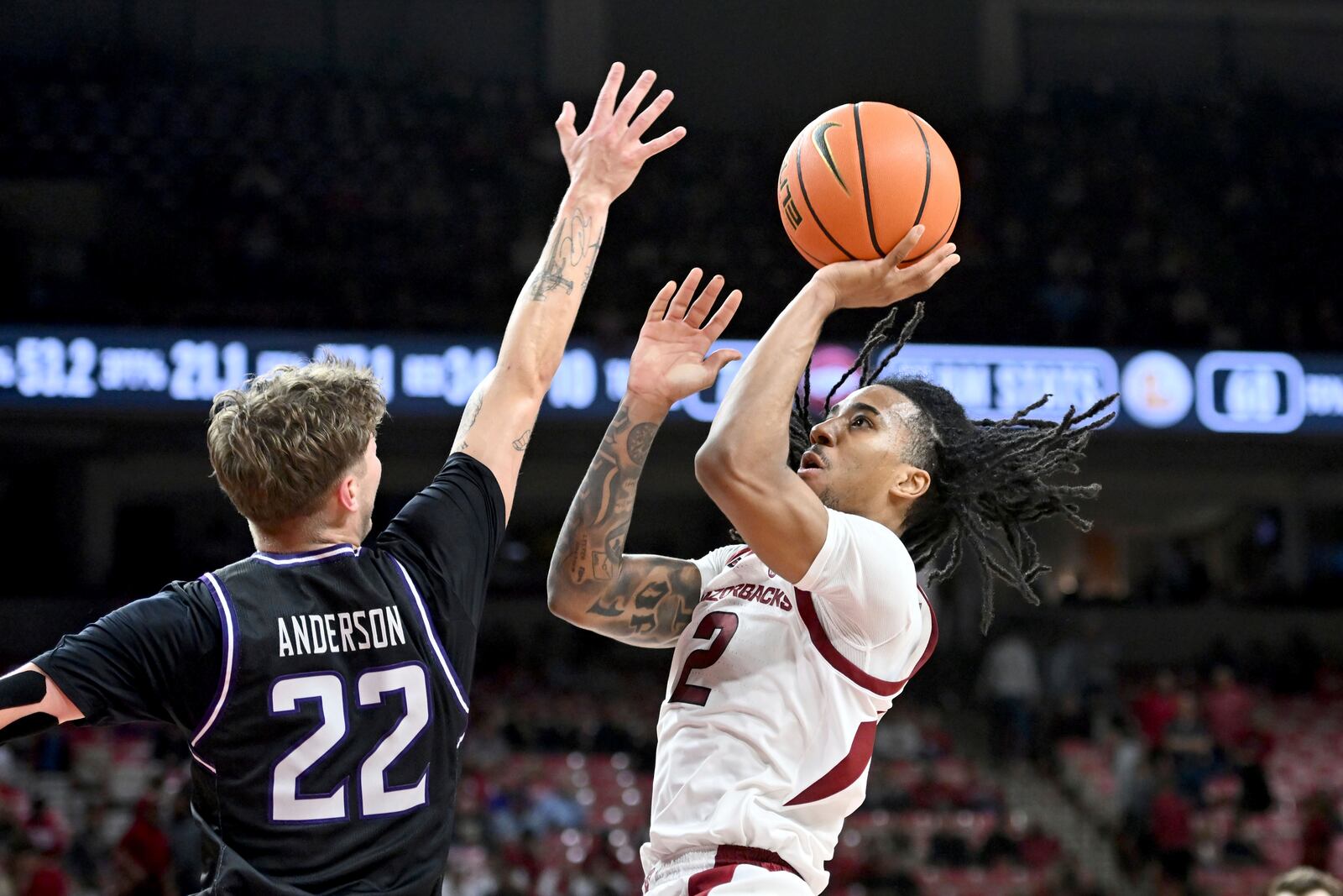 Arkansas guard Boogie Fland (2) shoots over Lipscomb guard Joe Anderson (22) during the second half of an NCAA college basketball game Wednesday, Nov. 6, 2024, in Fayetteville, Ark. (AP Photo/Michael Woods)