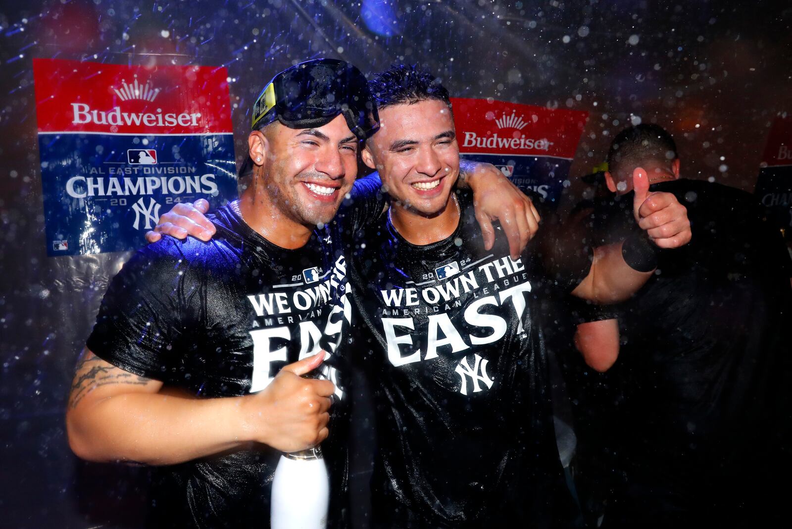 New York Yankees' Gleyber Torres, left, and Anthony Volpe, right, celebrate after clinching the American League East title in a baseball game against the Baltimore Orioles, Thursday, Sept. 26, 2024, in New York. (AP Photo/Noah K. Murray)