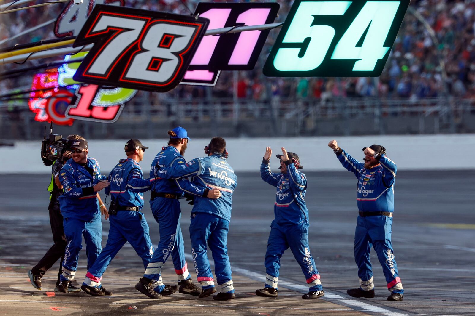 Driver Ricky Stenhouse Jr.'s pit crew celebrates after the win during a NASCAR Cup Series auto race at Talladega Superspeedway, Sunday, Oct. 6, 2024, in Talladega, Ala. (AP Photo/ Butch Dill)