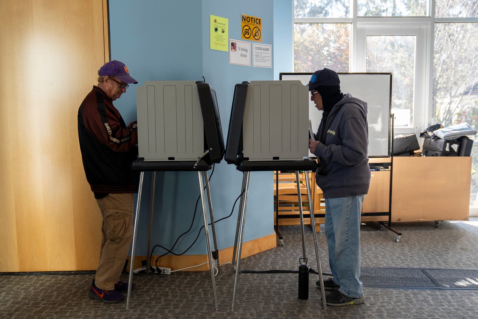 Voters mark their ballots during early in-person voting, Thursday, Oct. 17, 2024, in Asheville, N.C. (AP Photo/Stephanie Scarbrough)