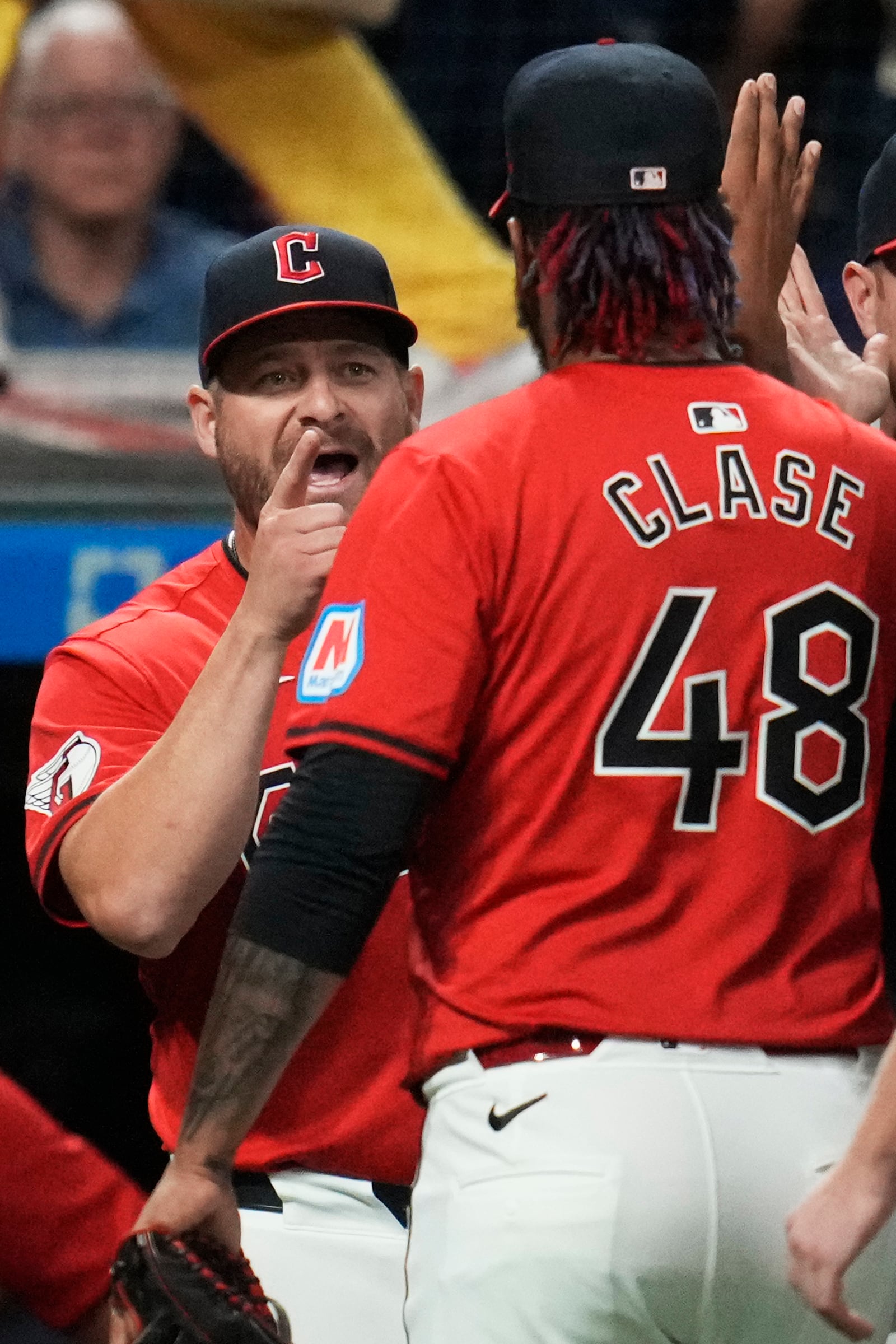 Cleveland Guardians manager Stephen Vogt, left, greets relief pitcher Emmanuel Clase (48) after they defeated the Minnesota Twins in a baseball game Monday, Sept. 16, 2024, in Cleveland. (AP Photo/Sue Ogrocki)