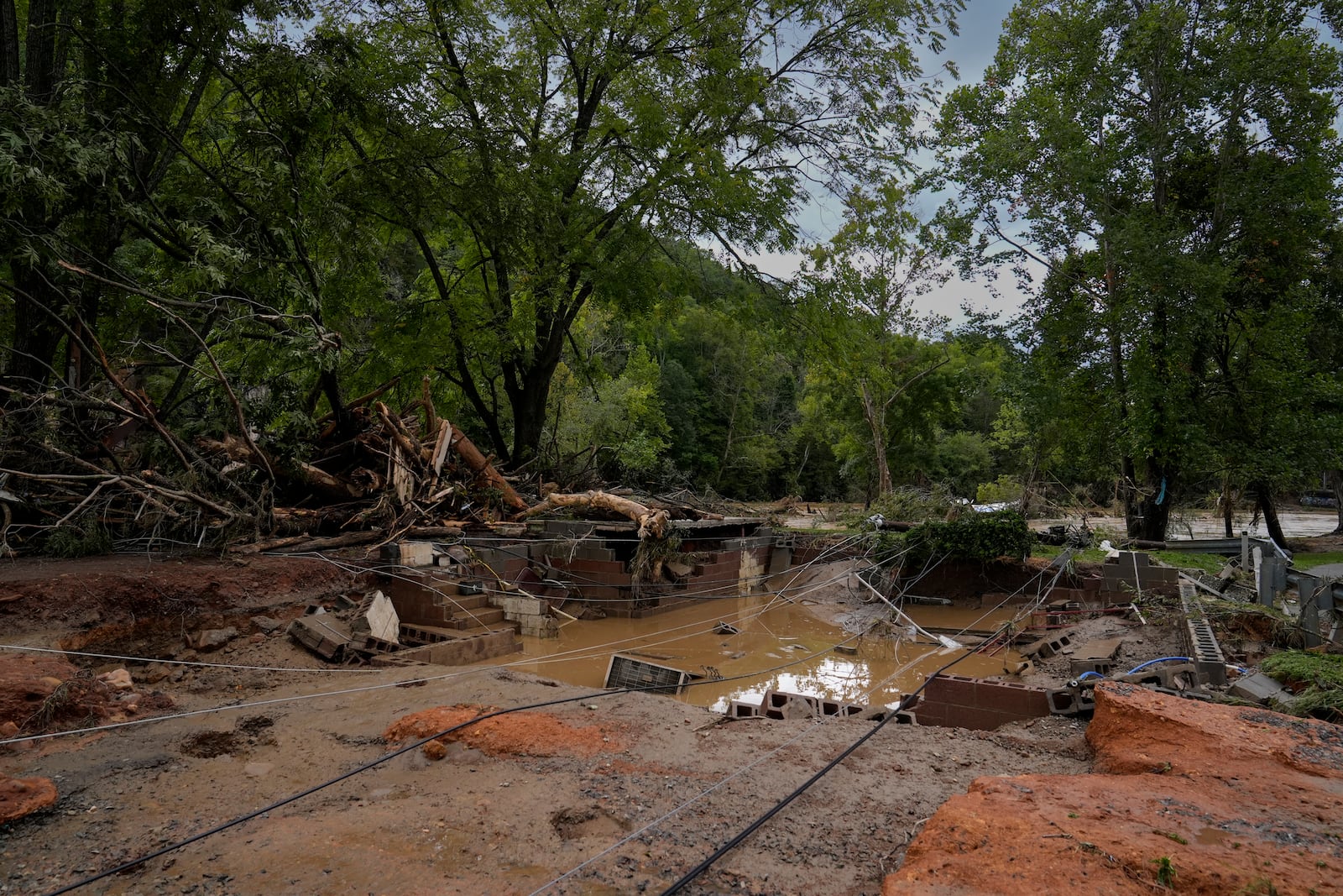 A home site destroyed by flood water is seen Saturday, Sept. 28, 2024, in Newport, Tenn. (AP Photo/George Walker IV)