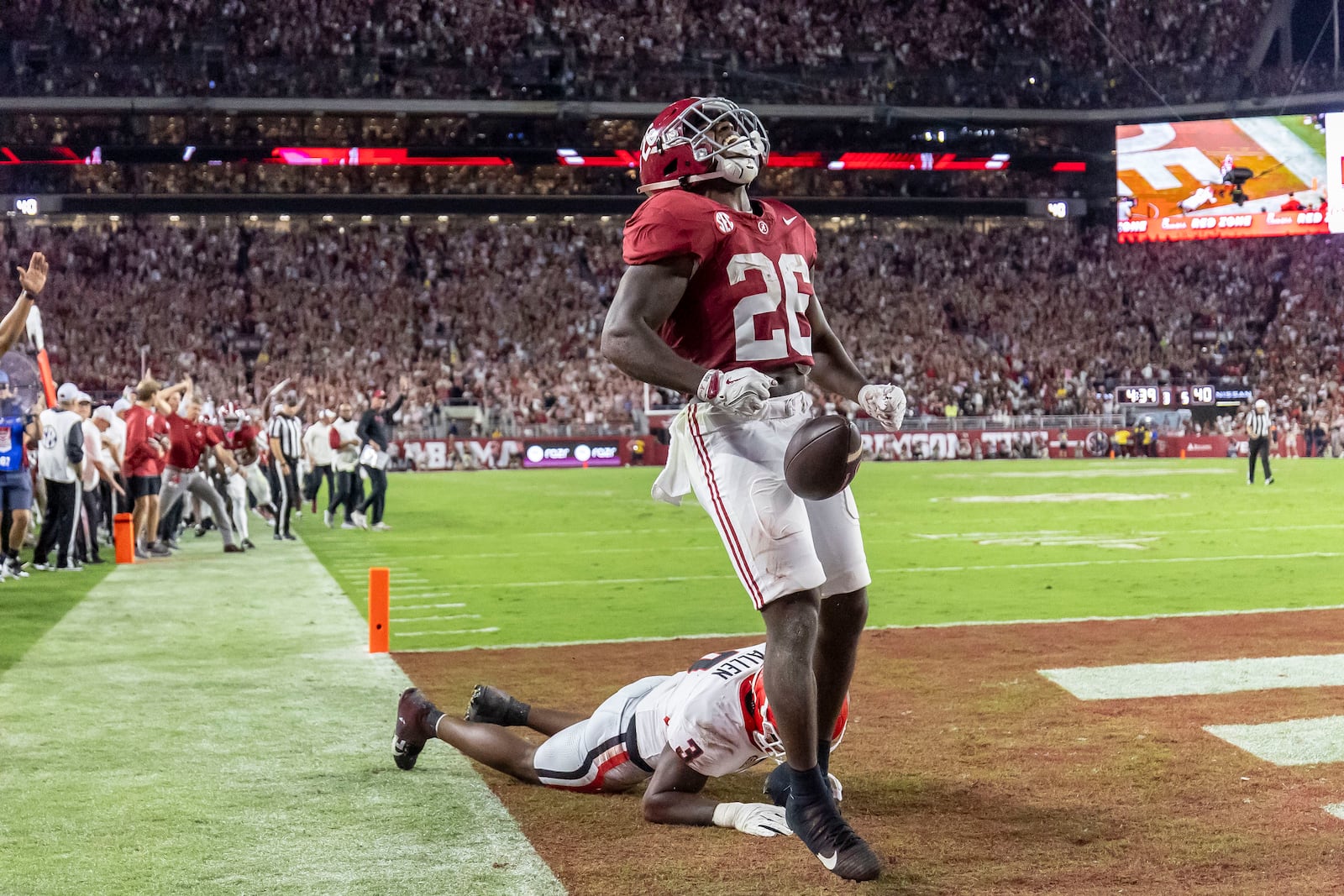 Alabama running back Jam Miller celebrates a touchdown after getting past Georgia linebacker CJ Allen during the first half of an NCAA college football game, Saturday, Sept. 28, 2024, in Tuscaloosa, Ala. (AP Photo/Vasha Hunt)