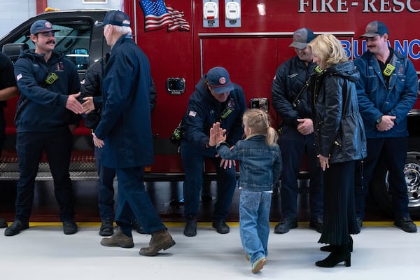 President Joe Biden, first lady Jill Biden and their grandson Beau shake hands with members of Nantucket fire department during a visit on Thanksgiving day in Nantucket Mass., Thursday, Nov. 28, 2024. (AP Photo/Jose Luis Magana)