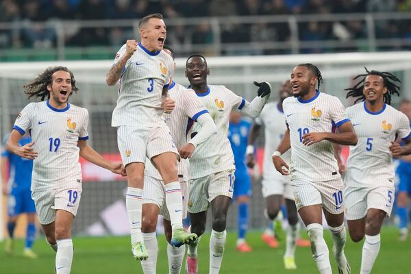 France's Lucas Digne, second from left, celebrates with teammates after Italy goalkeeper Guglielmo Vicario scored the own goal during the Nations League soccer match between Italy and France, at the San Siro stadium in Milan, Italy, Sunday, Nov. 17, 2024. (AP Photo/Luca Bruno)