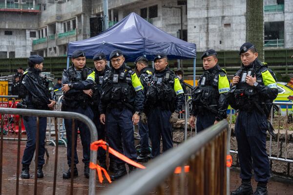 Police stand guard outside the West Kowloon Magistrates' Courts in Hong Kong, Wednesday, Nov. 20, 2024. (AP Photo/Chan Long Hei)