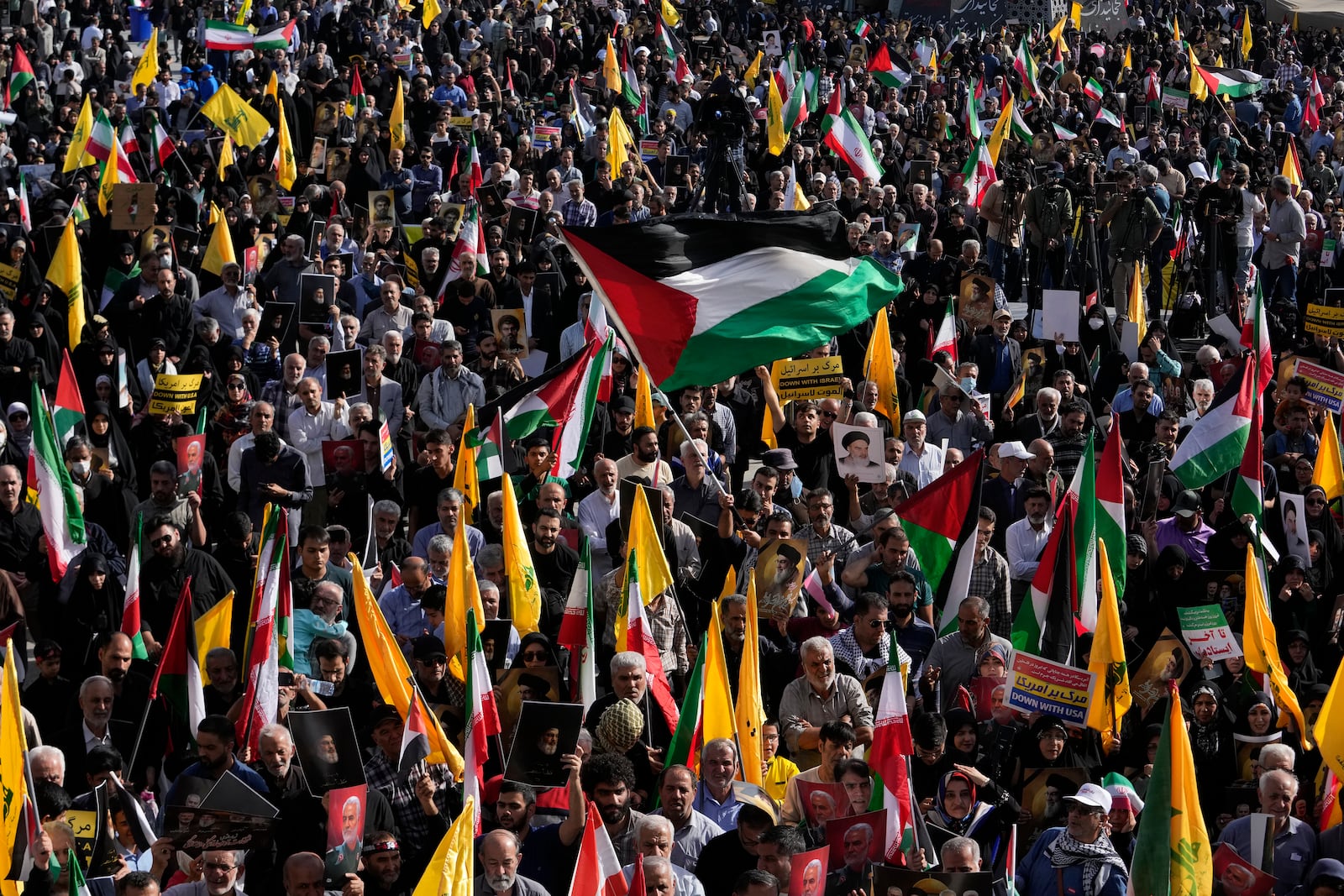 A demonstrator waves a Palestinian flag at a rally commemorating slain Hezbollah leader Hassan Nasrallah, in Tehran, Iran, Wednesday, Oct. 2, 2024. (AP Photo/Vahid Salemi)