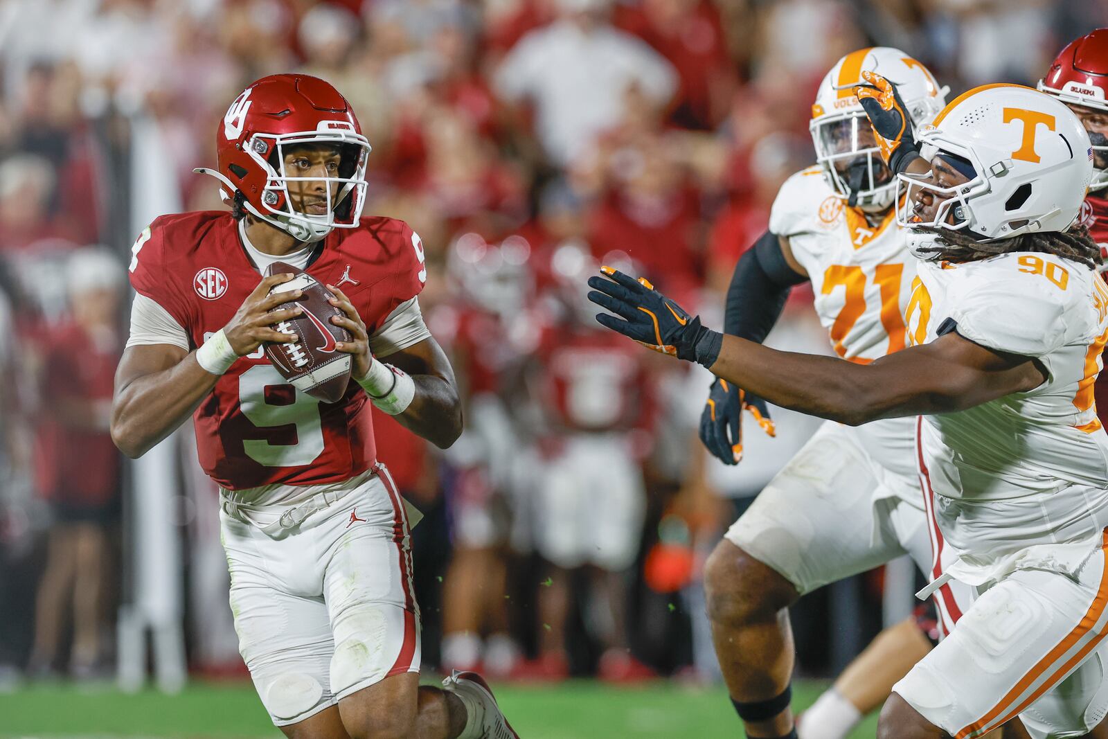 Oklahoma quarterback Michael Hawkins Jr. (9) passes under pressure by Tennessee defensive lineman Dominic Bailey (90) during the second of an NCAA college football game Saturday, Sept. 21, 2024, in Norman, Okla. (AP Photo/Alonzo Adams)