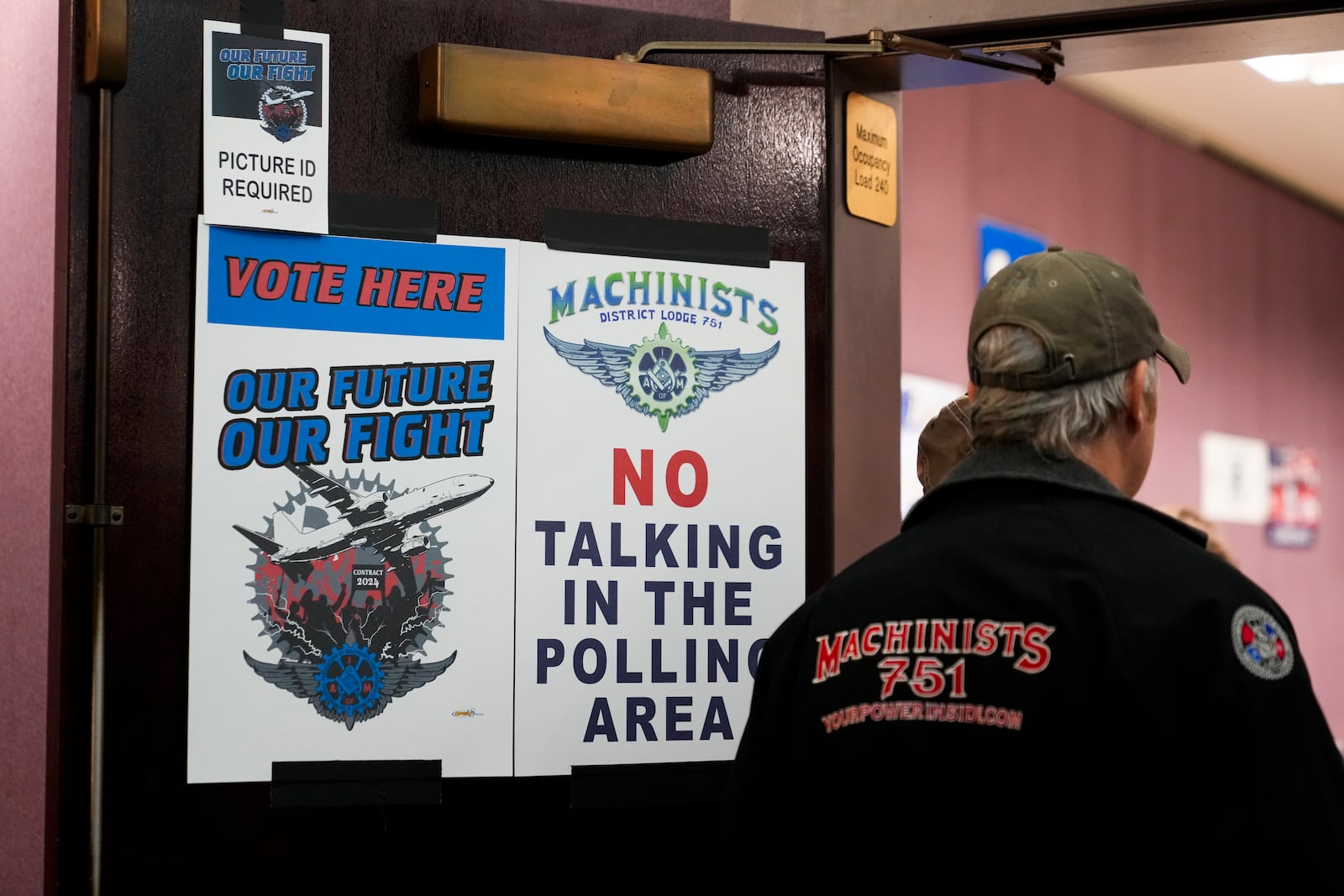 A worker watches as volunteers tally votes on a new contract offer from Boeing, Monday, Nov. 4, 2024, at IAM District 751 Union Hall in Seattle. (AP Photo/Lindsey Wasson)