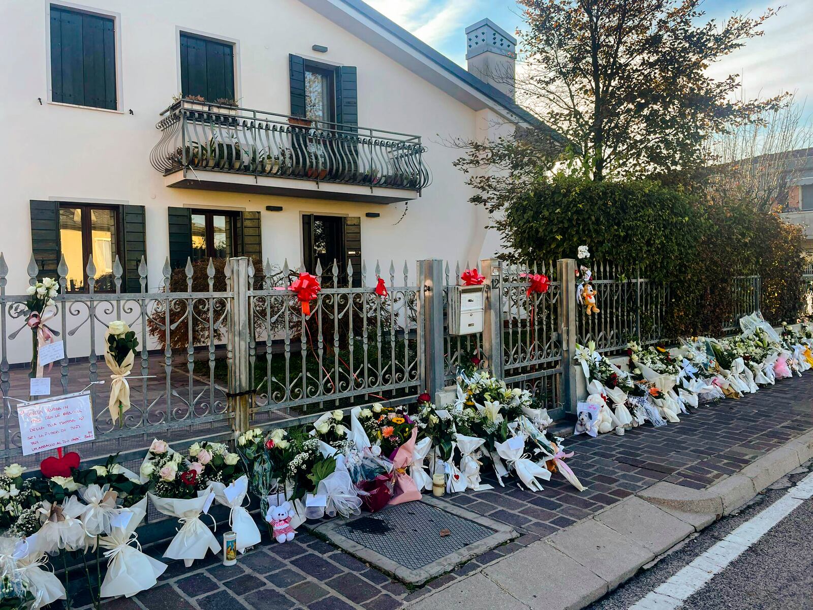 FILE - Flowers are left outside the house where 22-year-old Giulia Cecchettin used to live with her family in Vigonovo, near Venice, northern Italy, Sunday, Nov. 19, 2023. (Contaldo/LaPresse via AP, File)