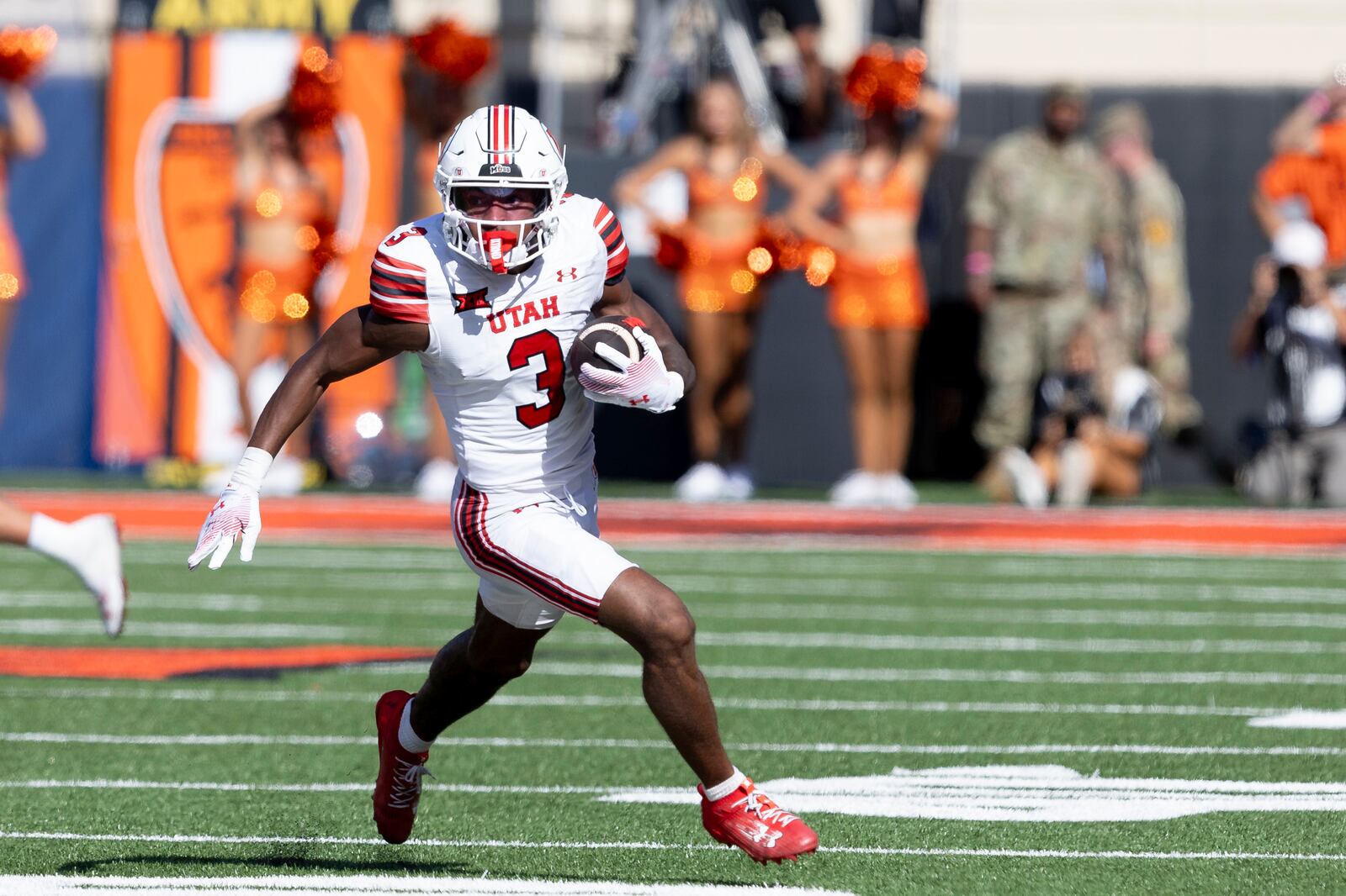 Utah wide receiver Dorian Singer runs with the ball in the first half of an NCAA college football game against Oklahoma State, Saturday, Sept. 21, 2024, in Stillwater, Okla. (AP Photo/Mitch Alcala)