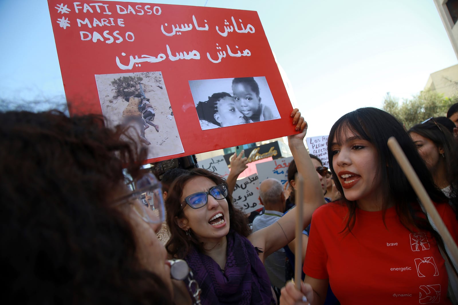 Members of the opposition and civil society groups shout slogans and wave placards during a demonstration against Tunisia president Kais Saied, ahead of the upcoming presidential elections, in Tunis, Friday, Sept. 27, 2024. Banner in Arabic reads: "We will not forgive, we will not forget." (AP Photo/Anis Mili)