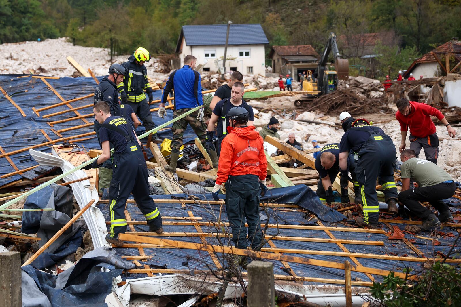 Rescuers search for missing people after floods and landslides in the village of Donja Jablanica, Bosnia, Saturday, Oct. 5, 2024. (AP Photo/Armin Durgut)