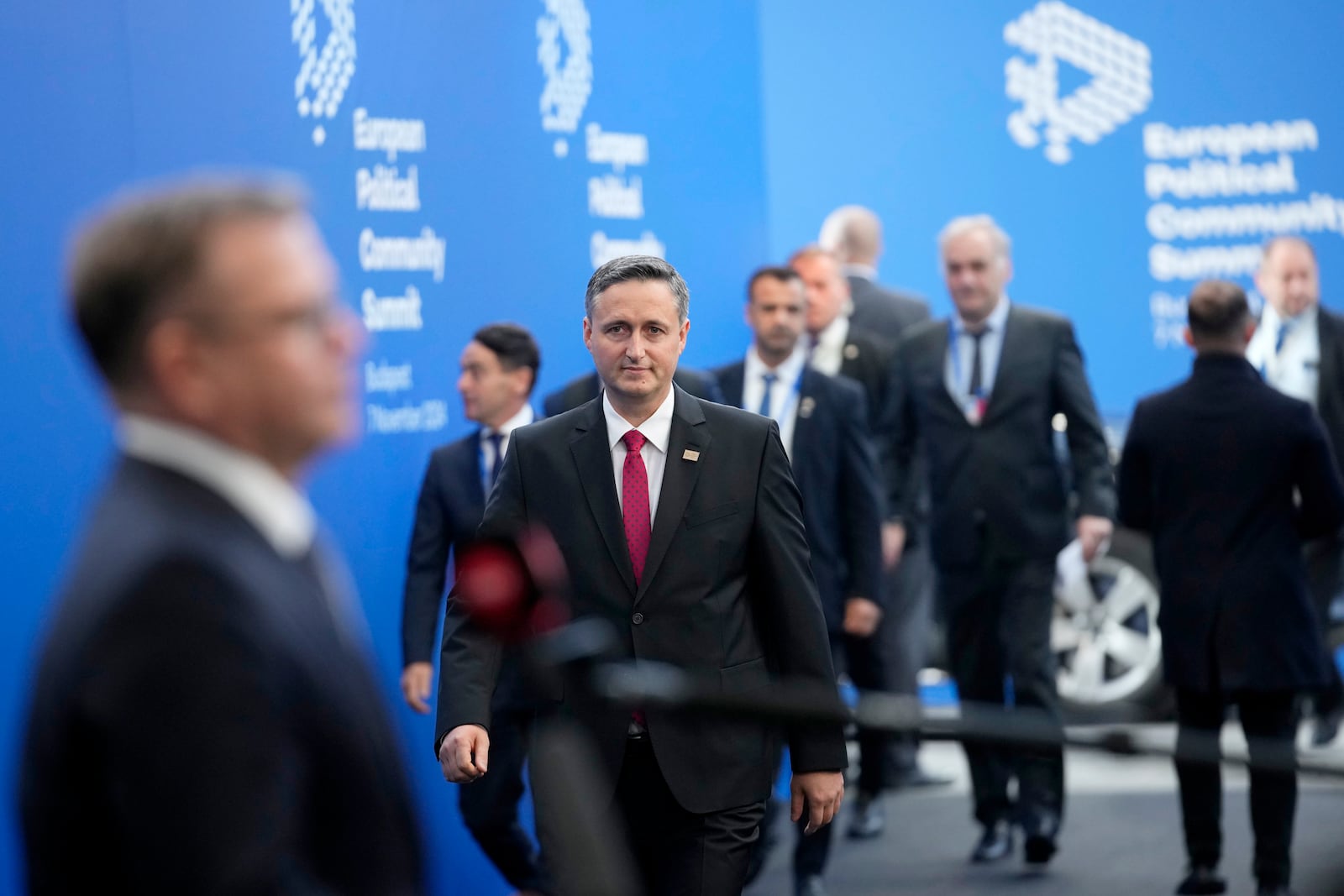 Chairman of the Presidency of Bosnia and Herzegovina Denis Becirovic, center, arrives for the European Political Community (EPC) Summit at the Puskas Arena in Budapest, Hungary, Thursday, Nov. 7, 2024. (AP Photo/Petr Josek)