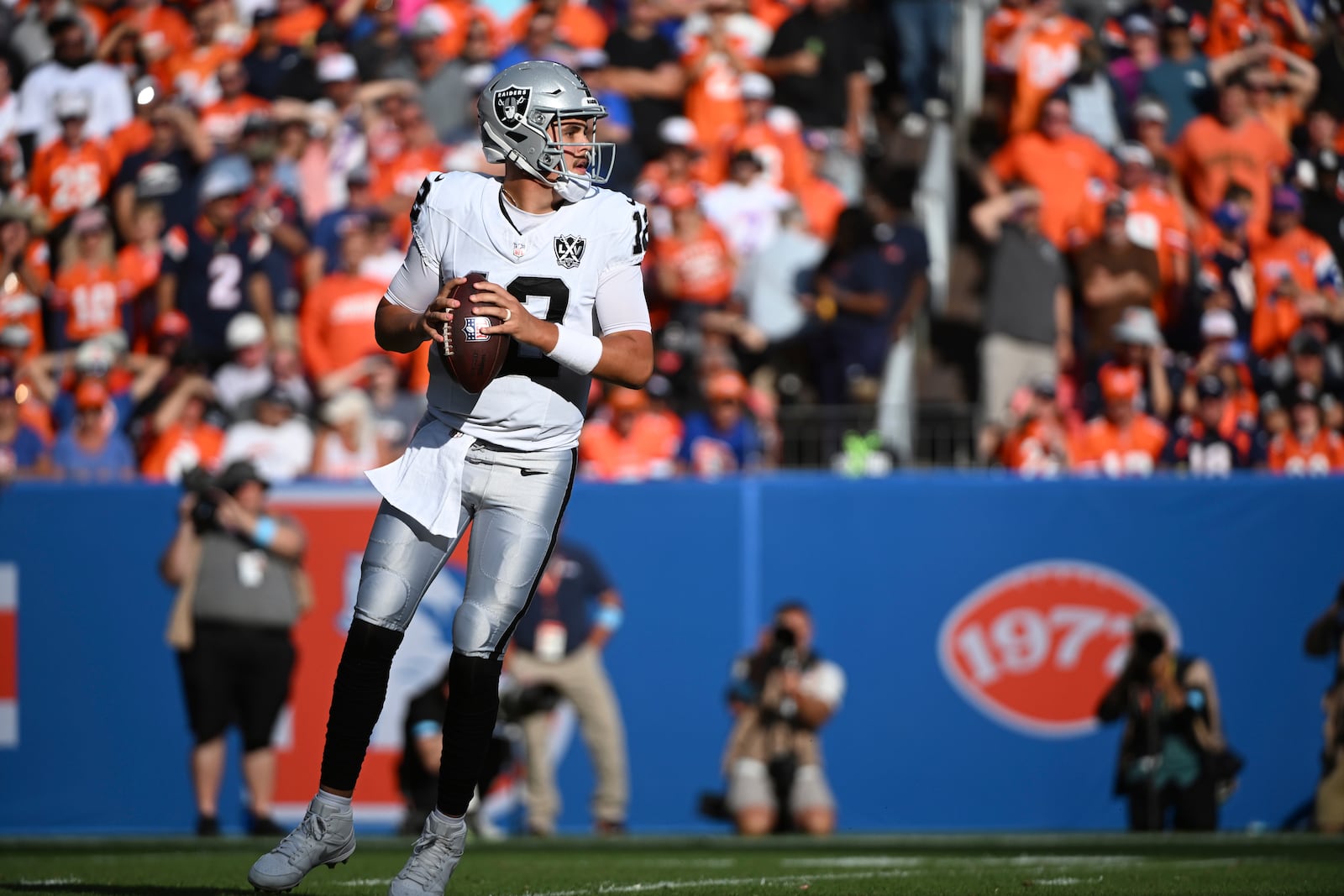 Las Vegas Raiders quarterback Aidan O'Connell (12) looks downfield during the second half of an NFL football game against the Denver Broncos, Sunday, Oct. 6, 2024, in Denver. (AP Photo/Geneva Heffernan)