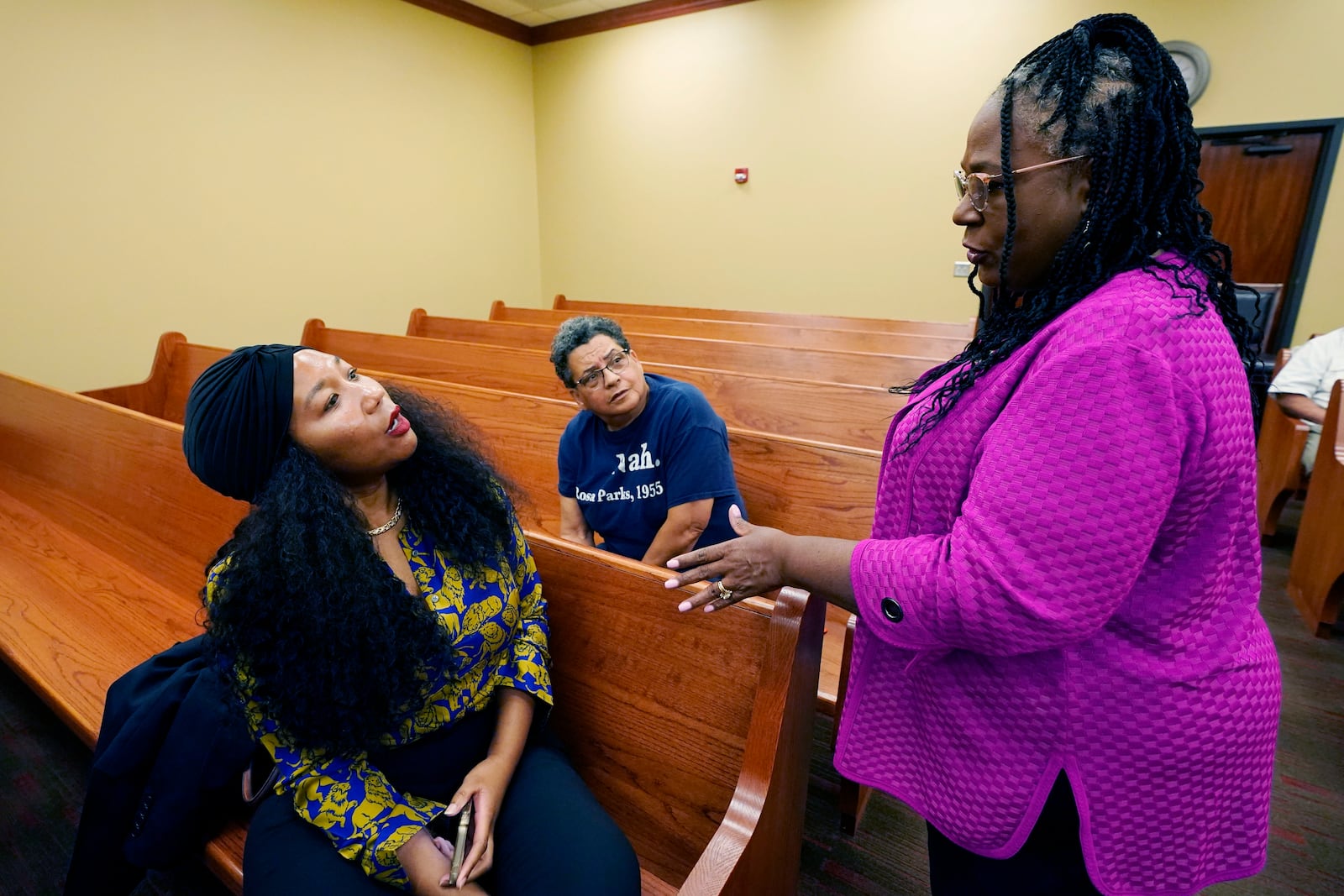 FILE - Jill Collen Jefferson, president of JULIAN, a civil rights and international human rights law firm, left, and Bonita Streeter, a bail bondsman and community activist, center, confer with Mitzi Dease Paige, an Assistant U.S. Attorney with the Southern District of Mississippi, right, during the Lexington, Miss., stop on the division's civil rights tour, June 1, 2023. (AP Photo/Rogelio V. Solis, File)