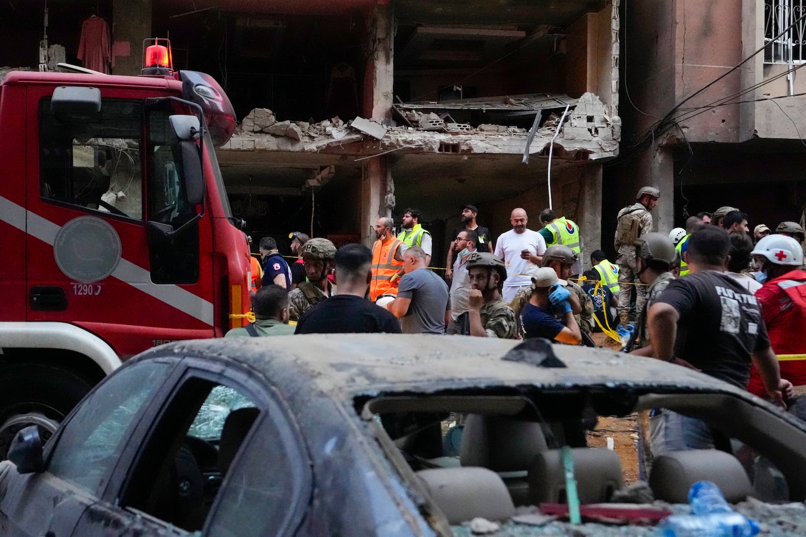 Rescuers work at the scene of an Israeli missile strike in the southern suburbs of Beirut, Friday, Sept. 20, 2024. (AP Photo/Hassan Ammar)