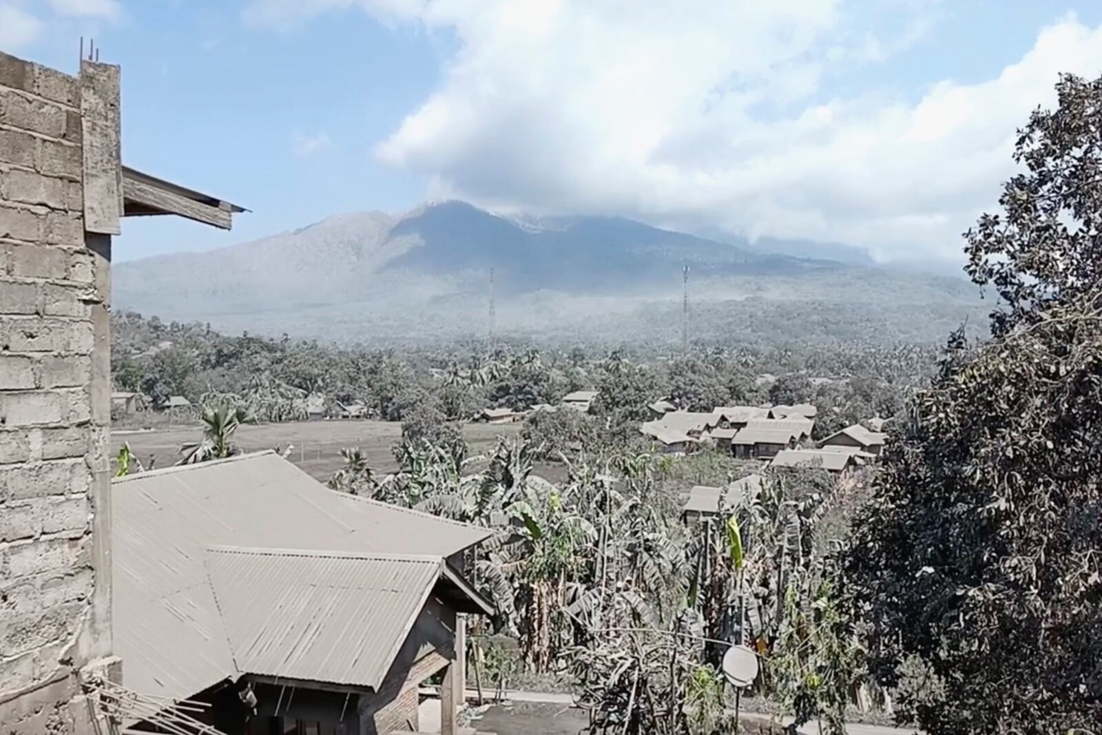 In this image made from AP video, Mount Lewotobi Lake-Laki spews volcanic smoke as village affected by its eruption is seen in the foreground in East Flores, Indonesia, Tuesday, Nov. 5, 2024. (AP Photo)