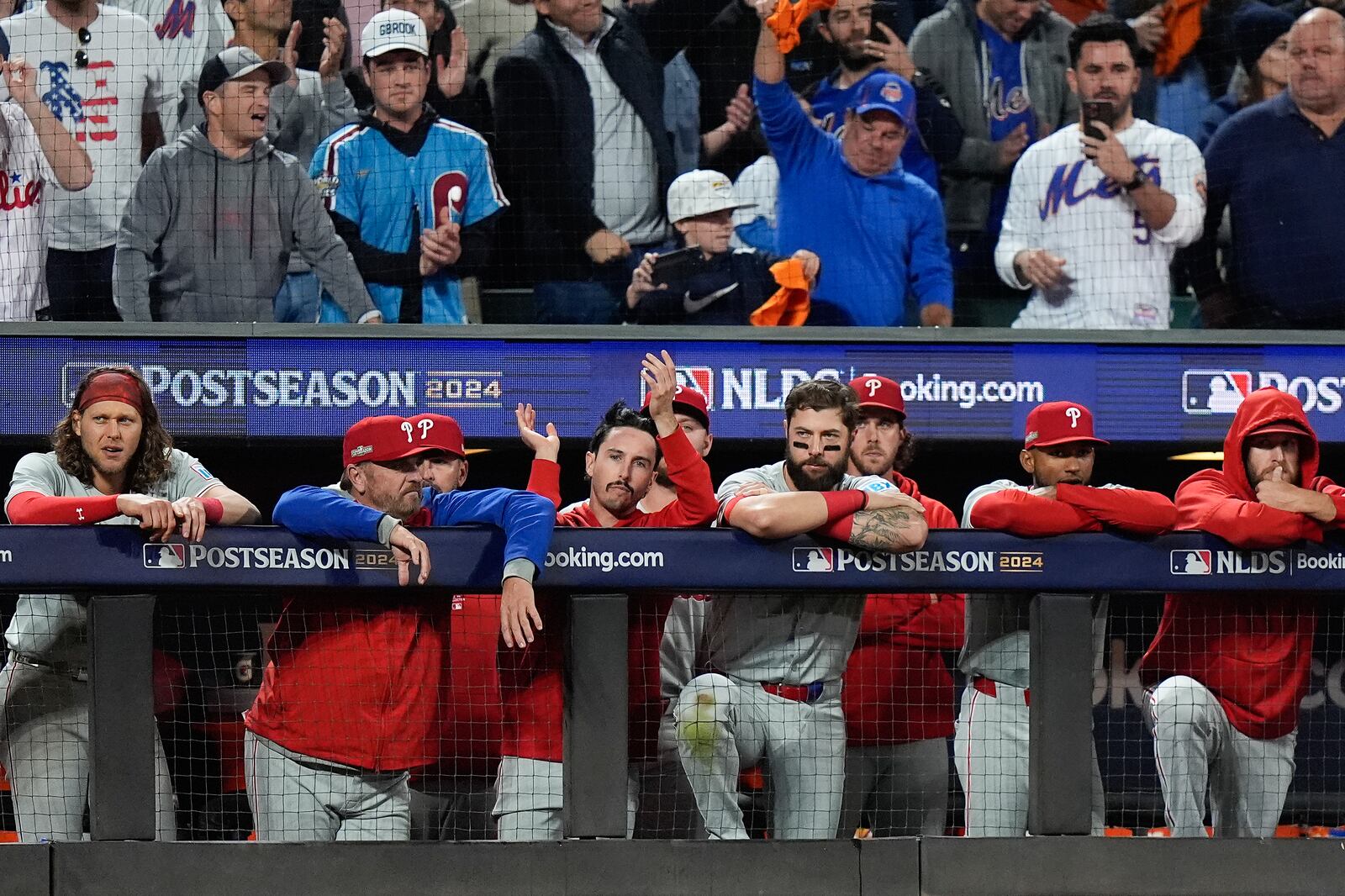 The Philadelphia Phillies watch play against the New York Mets in the ninth inning of Game 4 of the National League baseball playoff series, Wednesday, Oct. 9, 2024, in New York. (AP Photo/Frank Franklin II)