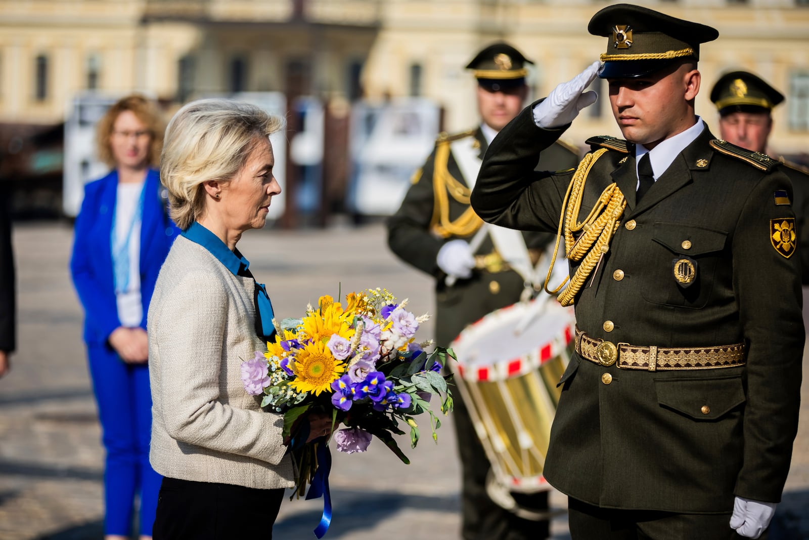 President of the European Commission Ursula von der Leyen, left, holds a bouquet of flowers to place at a wall commemorating the fallen Ukrainian soldiers in the war with Russia, in Kyiv, Ukraine, Friday, Sept. 20, 2024. (Christoph Soeder, Pool via AP)