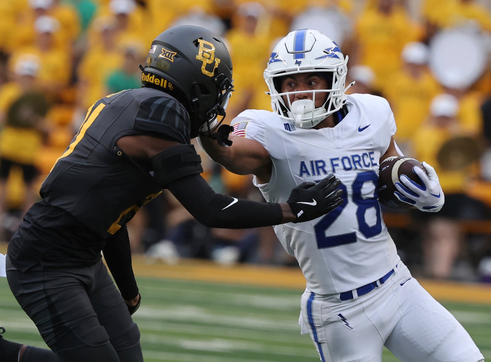 Air Force running back Aiden Calvert stiff-arms Baylor linebacker Keaton Thomas while running toward the sidelines during the first half of an NCAA college football game, Saturday, Sept. 14, 2024, in Waco, Texas. (Rod Aydelotte/Waco Tribune-Herald via AP)