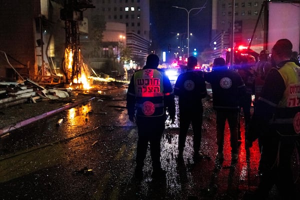 Security forces cordon and inspect the location of a rocket attack in Ramat Gan, Tel Aviv district, Israel, Monday Nov. 18, 2024. (AP Photo/Francisco Seco)