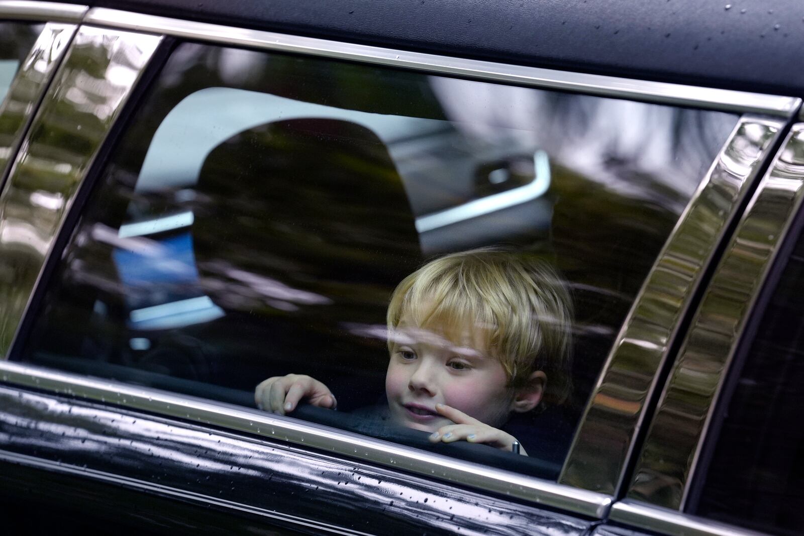 James Kennedy, great grandson of Ethel Kennedy, wife of Sen. Robert F. Kennedy, is seated in a vehicle that forms part of a funeral procession departing Our Lady of Victory church, following funeral services for Ethel Kennedy, Monday, Oct. 14, 2024, in Centerville, Mass. (AP Photo/Steven Senne)