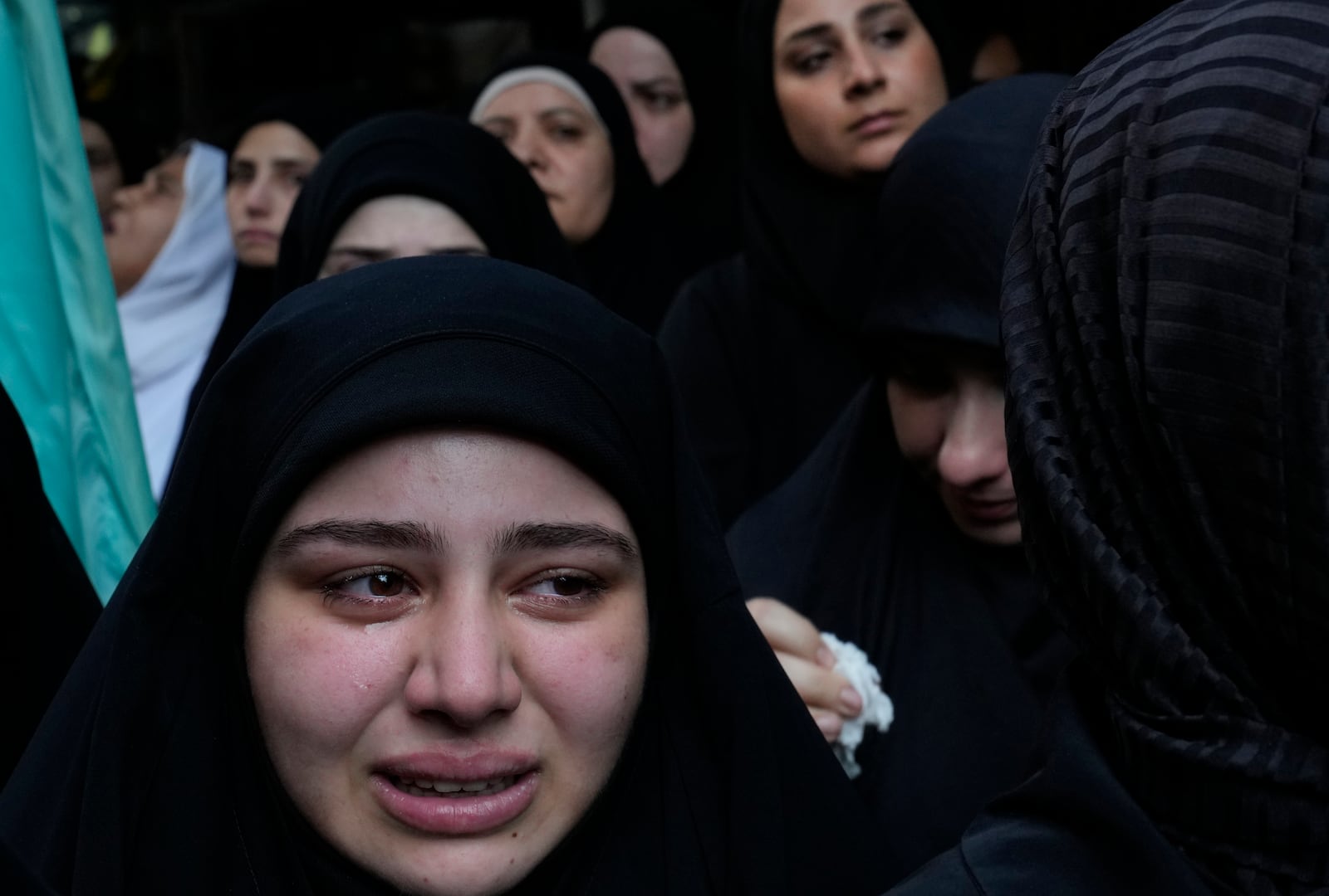 A woman cries during the funeral procession of two Hezbollah members, killed on Wednesday when a handheld device exploded, in the southern suburbs of Beirut, Lebanon, Thursday, Sept. 19, 2024. (AP Photo/Hussein Malla)