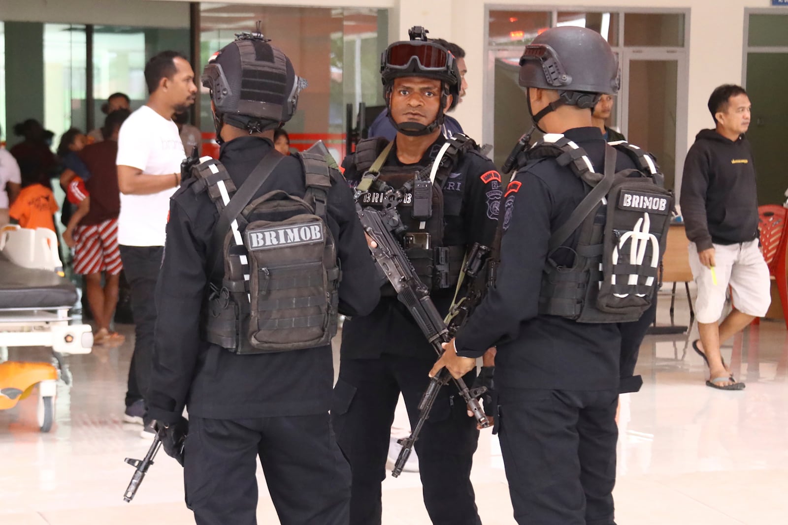 FILE - Police guard a hospital where workers threatened by Papuan rebels were brought for medical examinations in Mimika, Papua province, Indonesia, Wednesday, Feb. 8, 2023. Security forces evacuated the workers from an area where they were searching for a New Zealand pilot taken hostage by separatist rebels of the West Papua Liberation Army. (AP Photo/Saldi Hermanto, File)