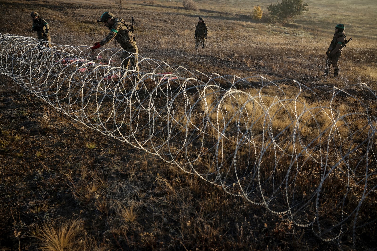 In this photo provided by Ukraine's 24th Mechanised Brigade press service, servicemen of the 24th Mechanised Brigade install anti-tank landmines and non explosive obstacles along the front line near Chasiv Yar town in Donetsk region, Ukraine, Wednesday Oct. 30, 2024. (Oleg Petrasiuk/Ukrainian 24th Mechanised Brigade via AP)