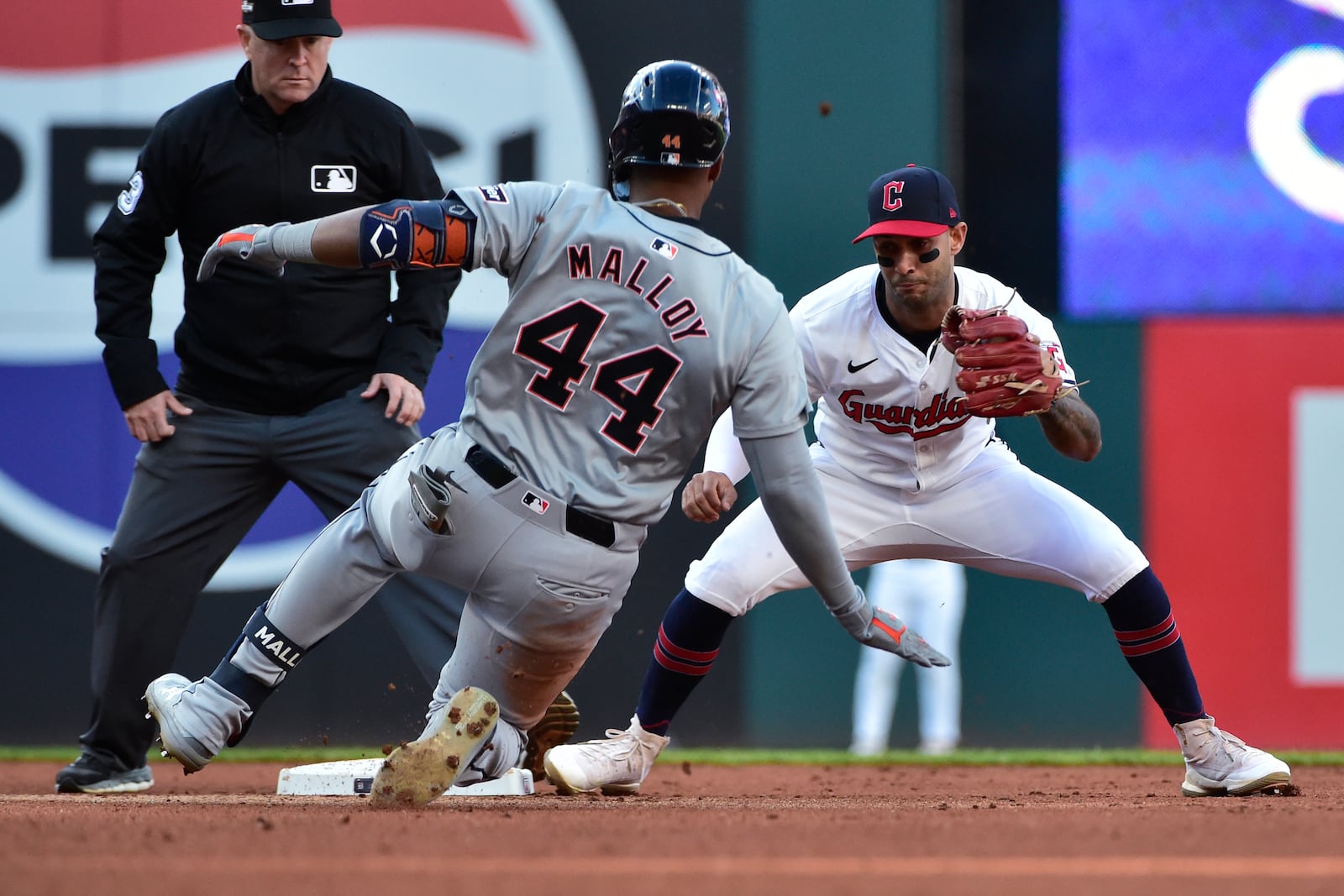 Cleveland Guardians shortstop Brayan Rocchio, right, prepares to tag out Detroit Tigers' Justyn-Henry Malloy (44) as Malloy attempts to stretch a single into a double in the fifth inning during Game 2 of baseball's AL Division Series, Monday, Oct. 7, 2024, in Cleveland. (AP Photo/Phil Long)