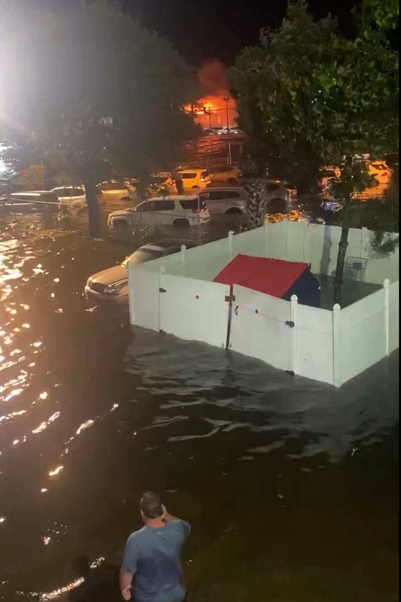 A person looks over a flooded street due to Hurricane Helene late Thursday, Sept. 26, 2024 in New Port Richey, Fla. (Danielle Molisee via AP)