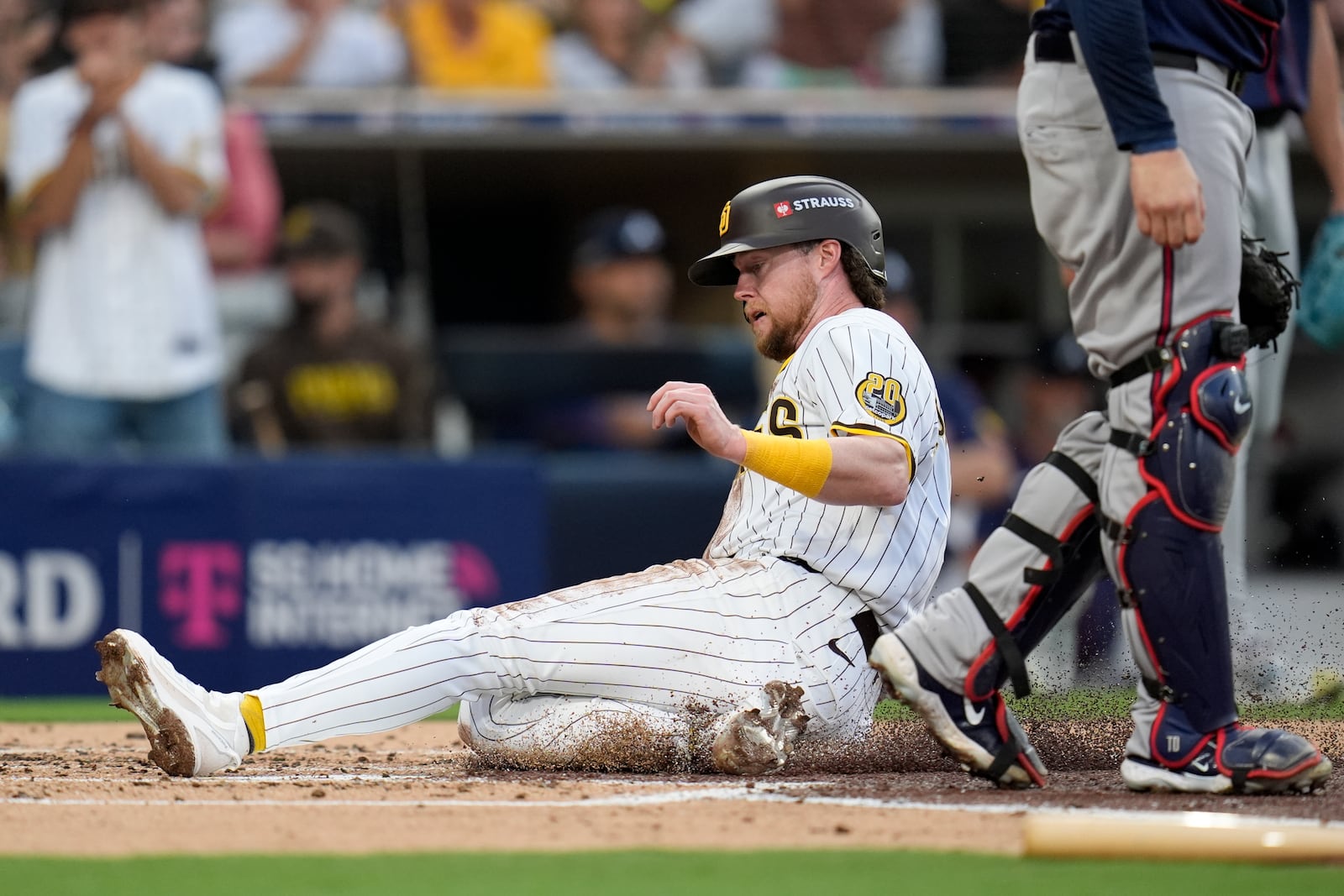 San Diego Padres' Jake Cronenworth scores on a sacrifice fly ball from Kyle Higashioka during the second inning in Game 1 of an NL Wild Card Series baseball game against the Atlanta Braves, Tuesday, Oct. 1, 2024, in San Diego. (AP Photo/Gregory Bull)