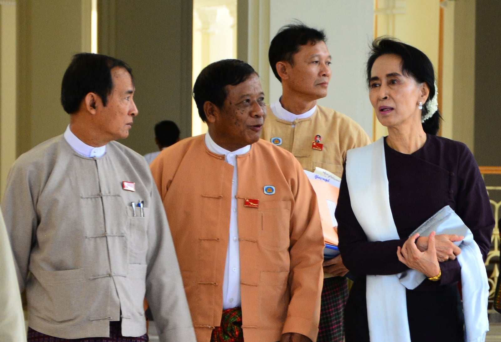 FILE - Zaw Myint Maung, center, an imprisoned politician and a close colleague of Myanmar’s ousted leader Aung San Suu Kyi, right, talks with Suu Kyi and Win Myint, left, at Parliament in Naypyitaw, Myanmar, on June 1, 2015. (AP Photo/Aung Shine Oo, File)