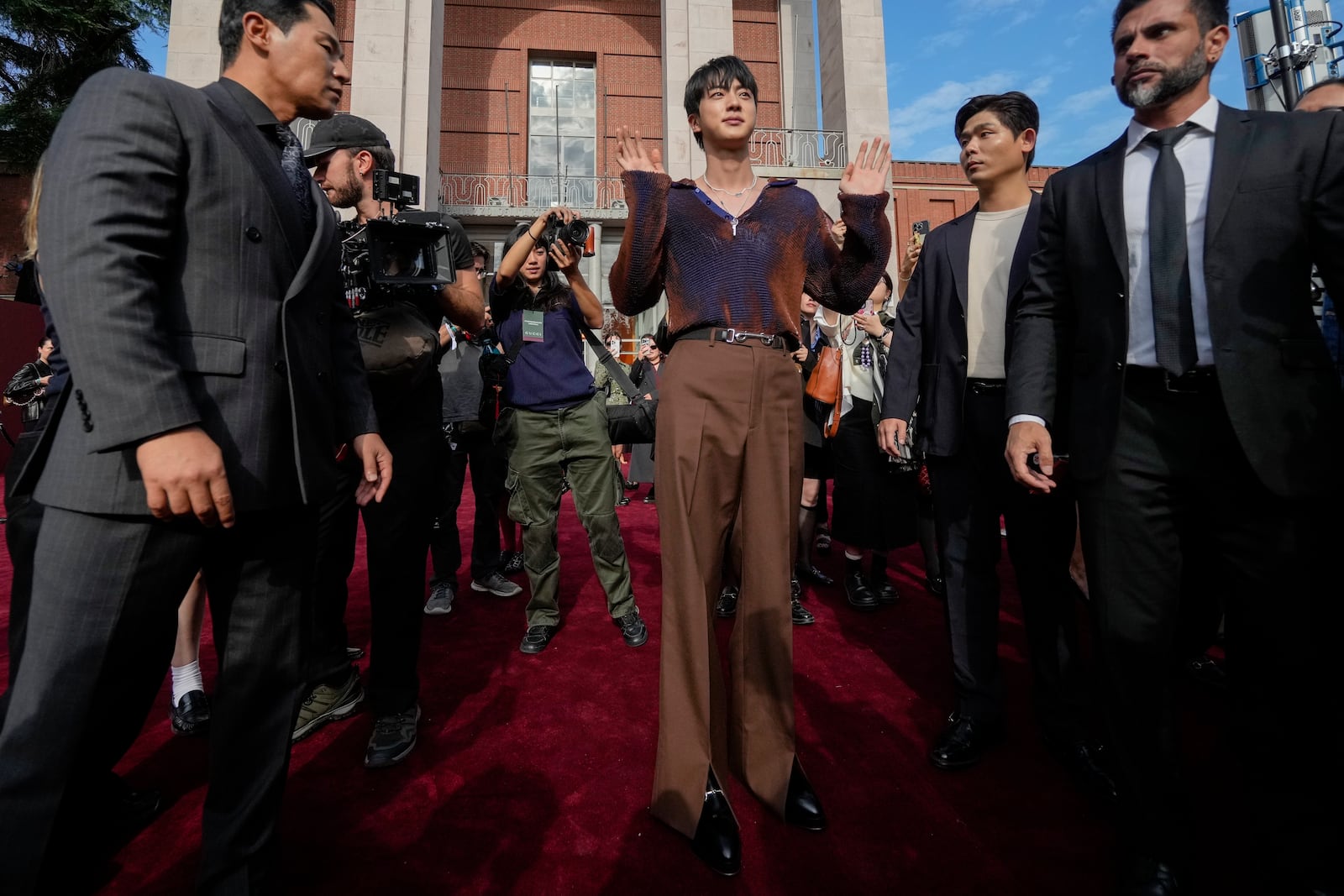 Jin departs the Gucci Spring Summer 2025 collection, that was presented in Milan, Italy, Friday, Sept. 20, 2024. (AP Photo/Luca Bruno).