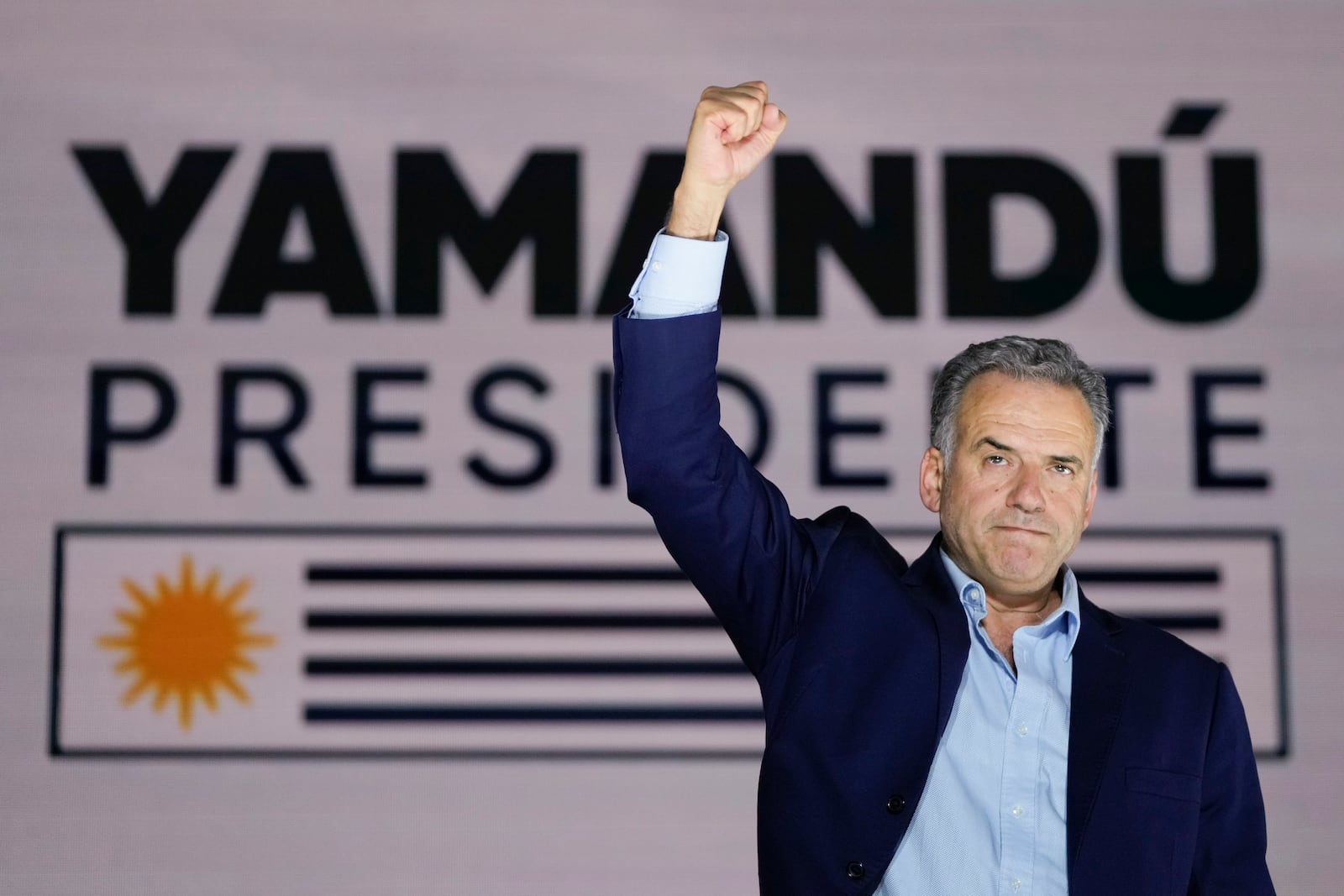 Frente Amplio presidential candidate Yamandu Orsi gestures to supporters outside of a hotel after general elections polls closed in Montevideo, Uruguay, Sunday, Oct. 27, 2024. (AP Photo/Natacha Pisarenko)