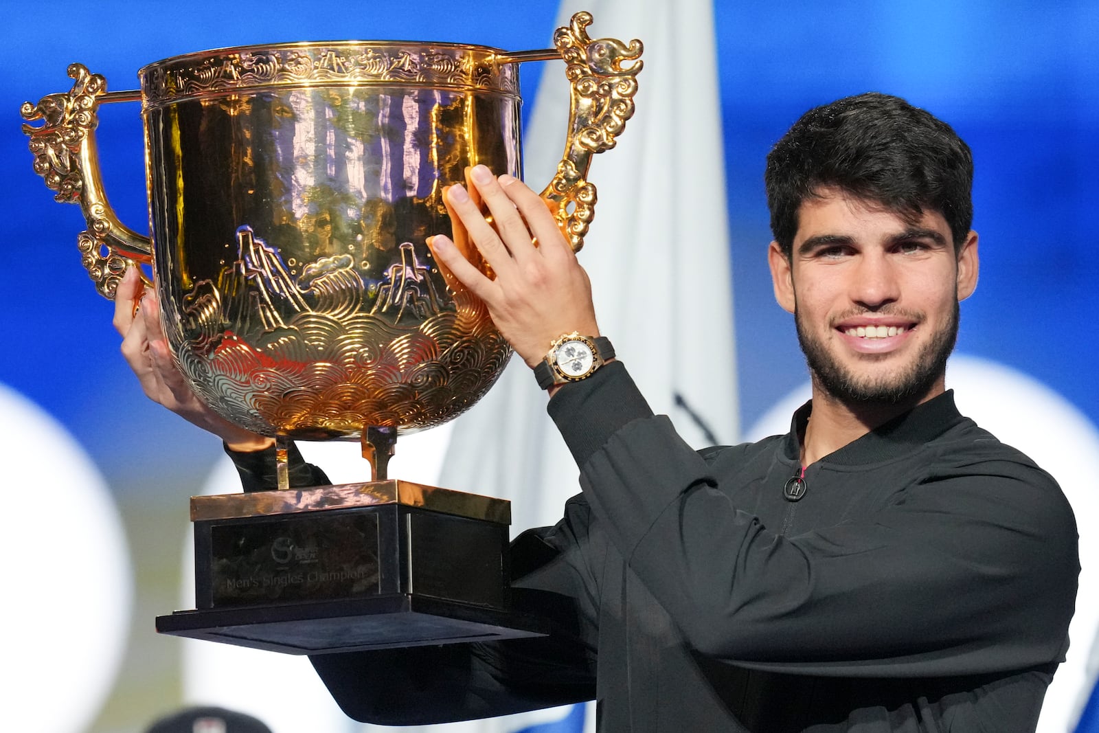 Carlos Alcaraz of Spain poses with his trophy after winning against Jannik Sinner of Italy during their men's singles finals match of the China Open tennis tournament, at the National Tennis Center in Beijing, Wednesday, Oct. 2, 2024. (AP Photo/Achmad Ibrahim)